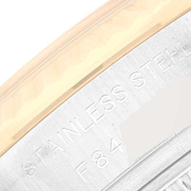 This image shows a close-up of the edge and engraved back casing of a Rolex Datejust 179173 Women's Steel and Gold (two tone) Mother of Pearl Dial 179173 Women's Steel and Gold (two tone) Mother of Pearl Dial watch, highlighting "STAINLESS STEEL".