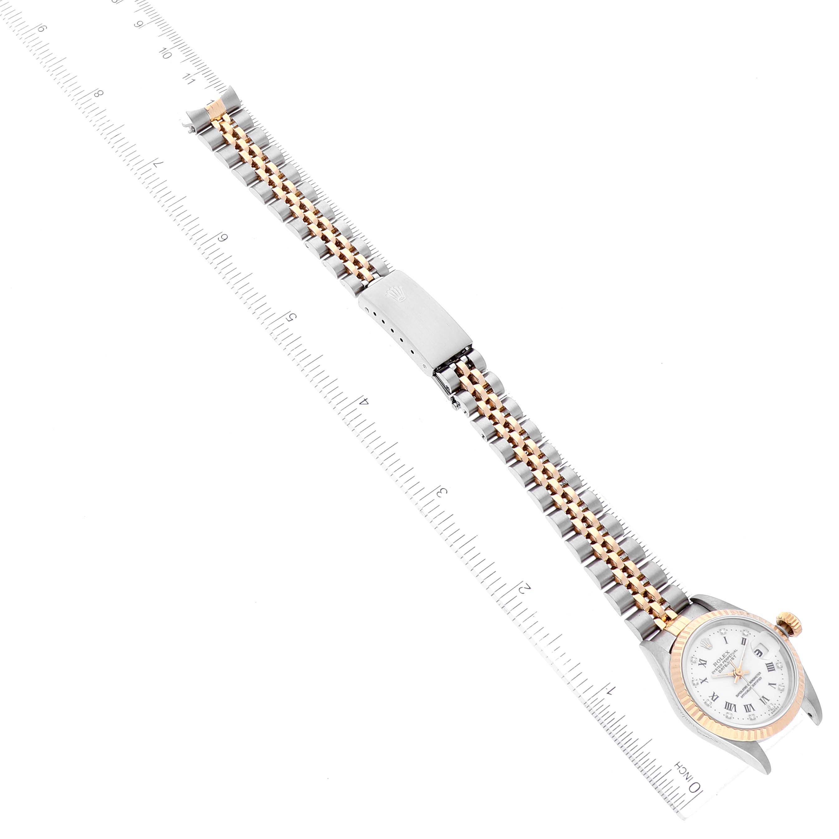 The image shows a Rolex Datejust 69173 Women's Steel and Gold (two tone) White Dial 69173 Women's Steel and Gold (two tone) White Dial watch from a top-down angle, including the entire band, clasp, and face of the watch.