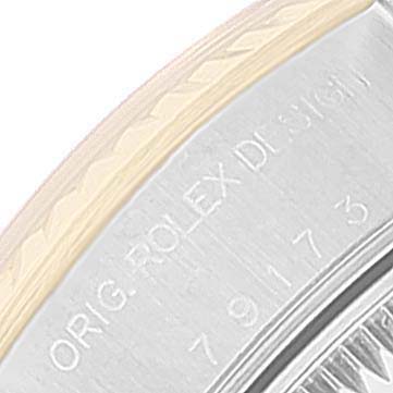 The image shows a close-up of the side of a Rolex Datejust 79173 Women's Steel and Gold (two tone) Silver Dial 79173 Women's Steel and Gold (two tone) Silver Dial watch case, highlighting the engraved text "ORIG. ROLEX DESIGN" and a serial number.