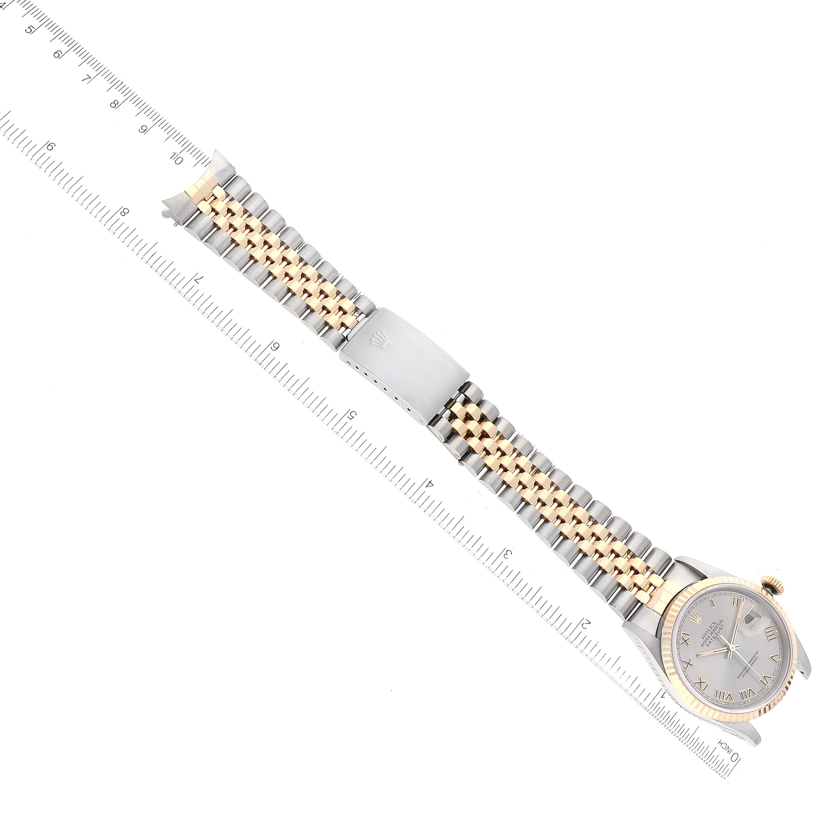 The image shows a Rolex Datejust 16233 Men's Steel and Gold (two tone) Grey Dial 16233 Men's Steel and Gold (two tone) Grey Dial watch placed diagonally with a two-tone bracelet and part of a ruler along its side for scale.