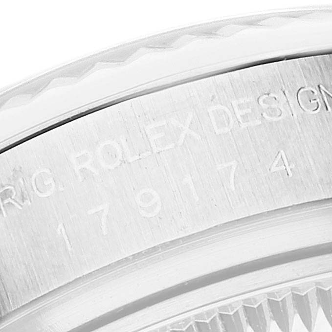 This image shows a close-up of the case side of a Rolex Datejust 179174 Women's Steel and Gold (two tone) Black Dial 179174 Women's Steel and Gold (two tone) Black Dial, revealing the engraved brand and model number.