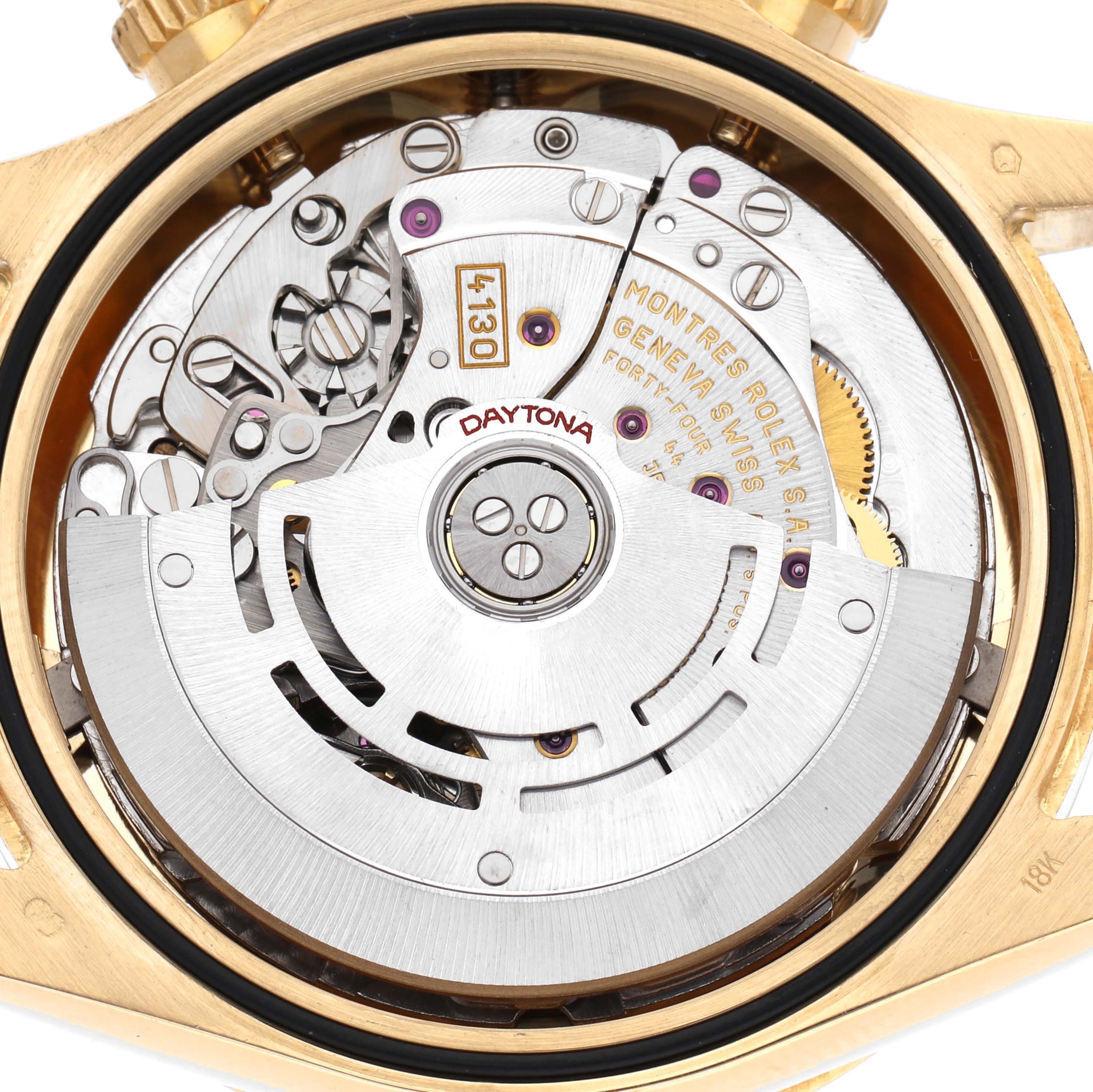 The image shows the back view of a Rolex Daytona 116528 Men
s Yellow Gold Black Dial 116528 Men
s Yellow Gold Black Dial watch, highlighting its intricate movement mechanisms.