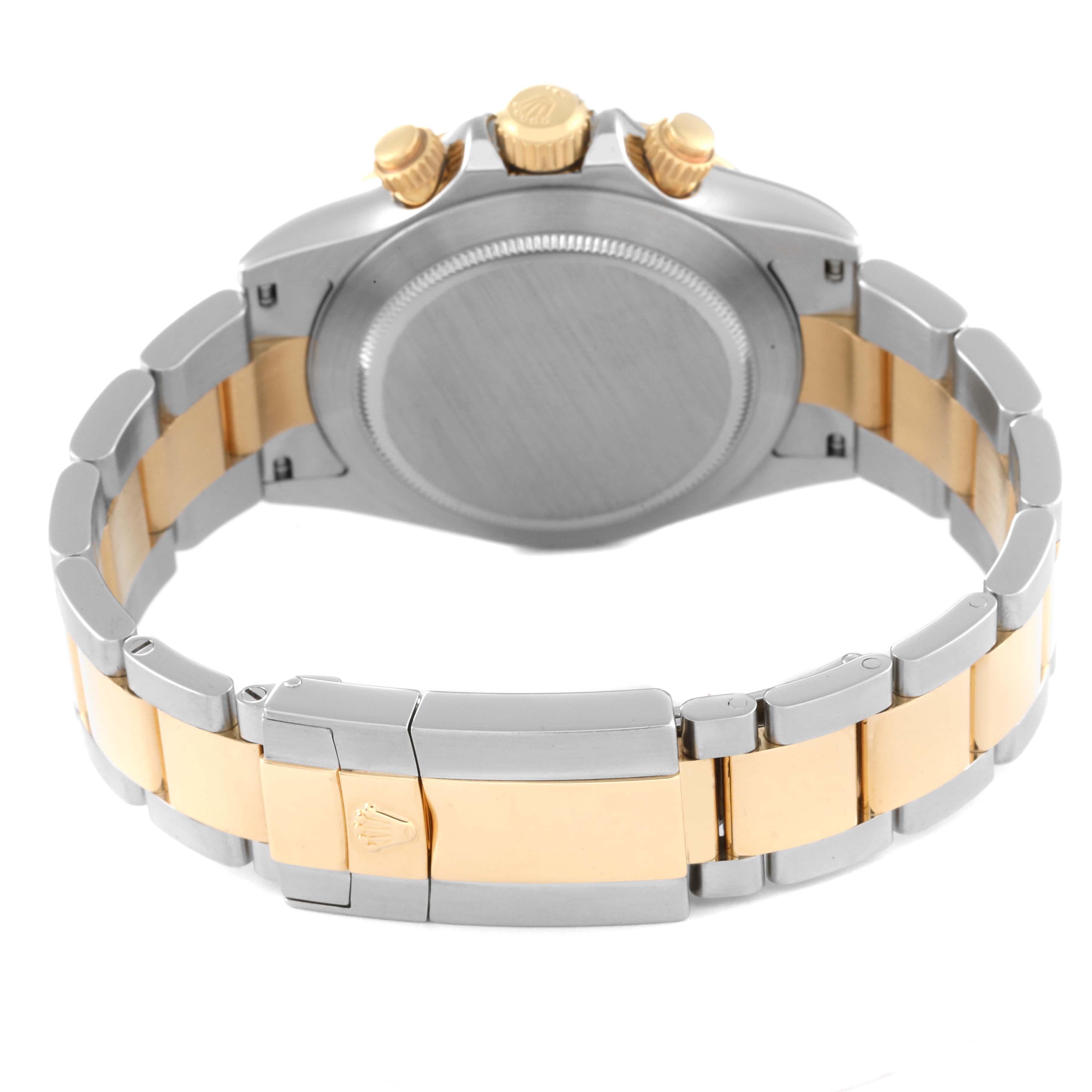 The image shows the back view of a Rolex Daytona 116523 Men
s Steel and Gold (two tone) White Dial 116523 Men
s Steel and Gold (two tone) White Dial watch, highlighting the bracelet clasp and crown pushers.