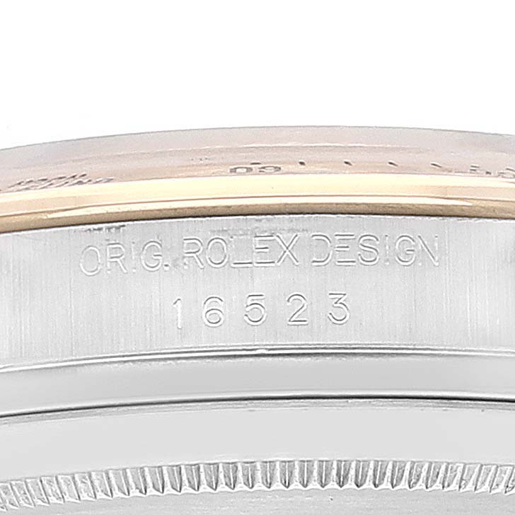The image shows the side of a Rolex Daytona 16523 Men
s Steel and Gold (two tone) White Dial 16523 Men
s Steel and Gold (two tone) White Dial watch case with the reference number 16523 engraved.