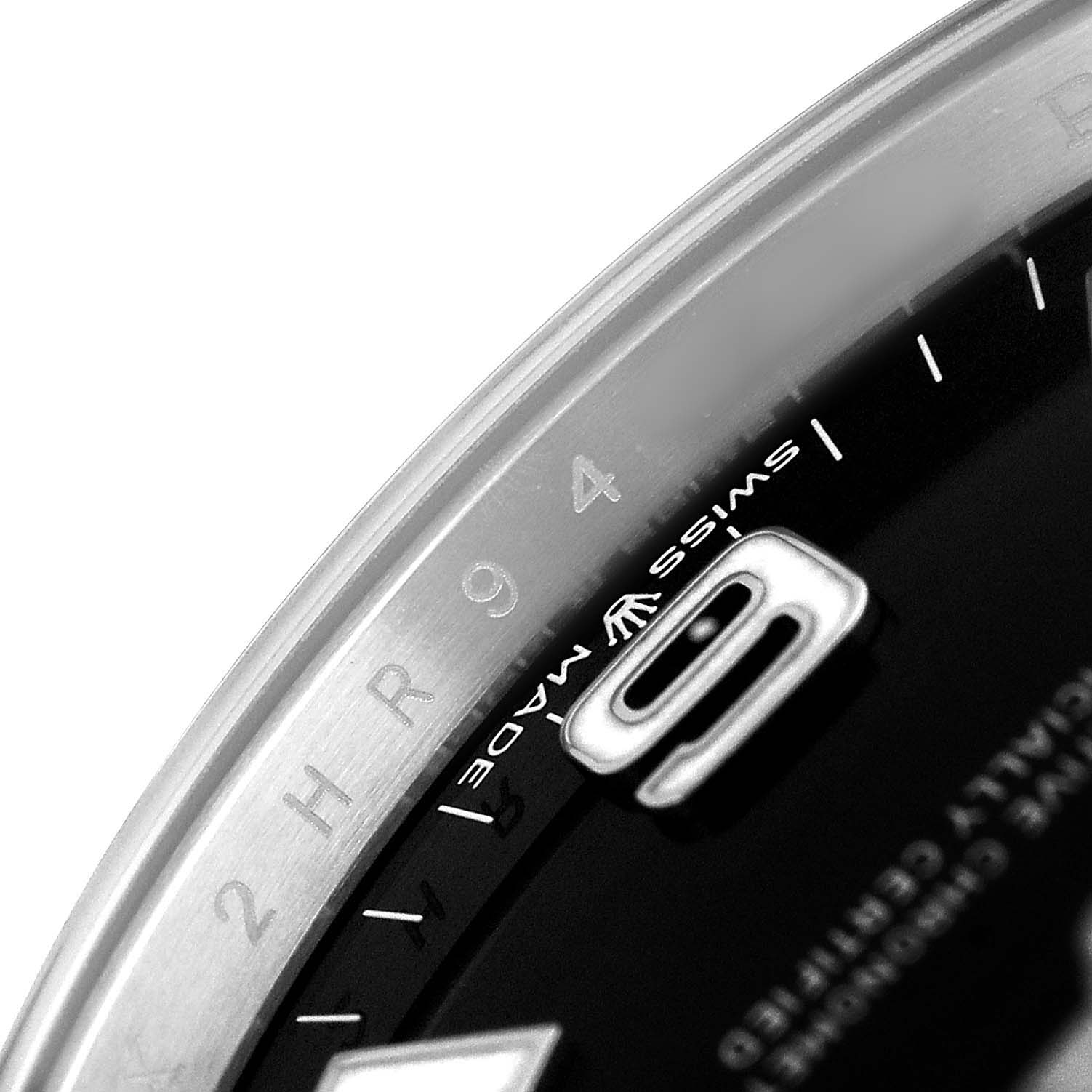 The close-up angle of the Rolex Explorer 224270 Men's Stainless Steel Black Dial watch shows part of the dial with "Swiss Made" text and the edge of the bezel.