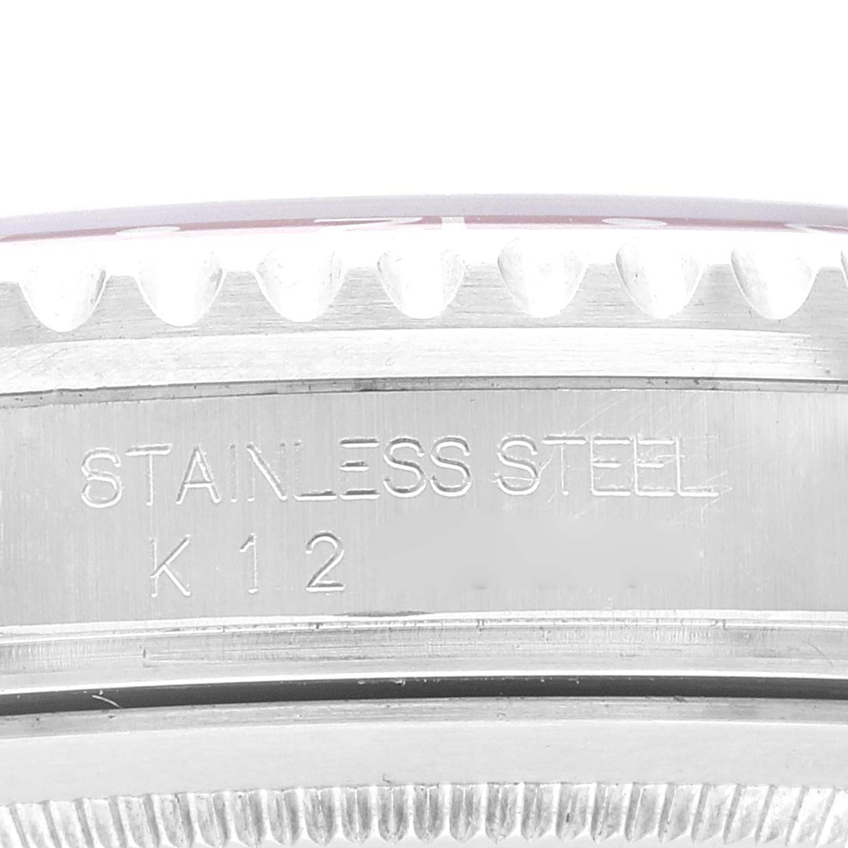The image shows a close-up angle of the case side of a Rolex GMT-Master 16710 Men
s Stainless Steel Black Dial 16710 Men
s Stainless Steel Black Dial watch, highlighting the "Stainless Steel" engraving.