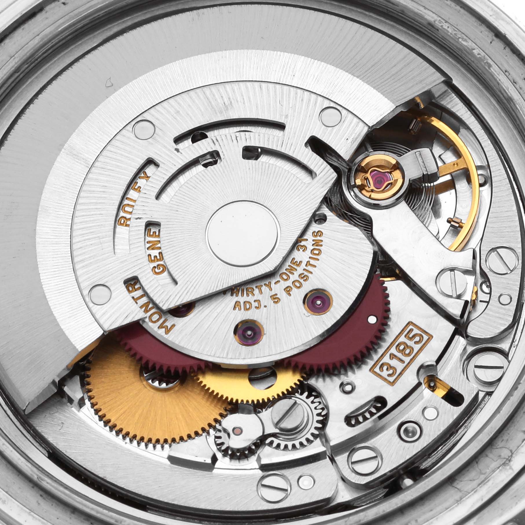 The image shows an angled close-up of the movement inside a Rolex GMT-Master 16710 Men's Stainless Steel Black Dial 16710 Men's Stainless Steel Black Dial, featuring gears, rotors, and inscriptions.