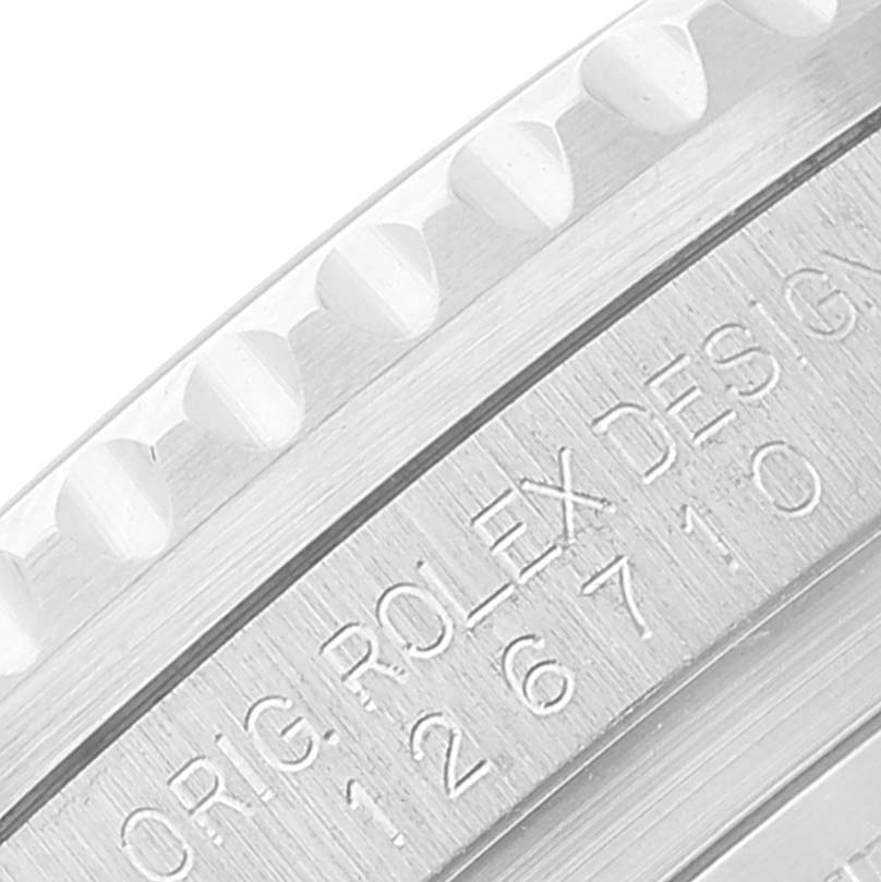 This close-up image shows the engraved bezel and edge of a Rolex GMT-Master 126710 Men's Stainless Steel Black Dial 126710 Men's Stainless Steel Black Dial model.