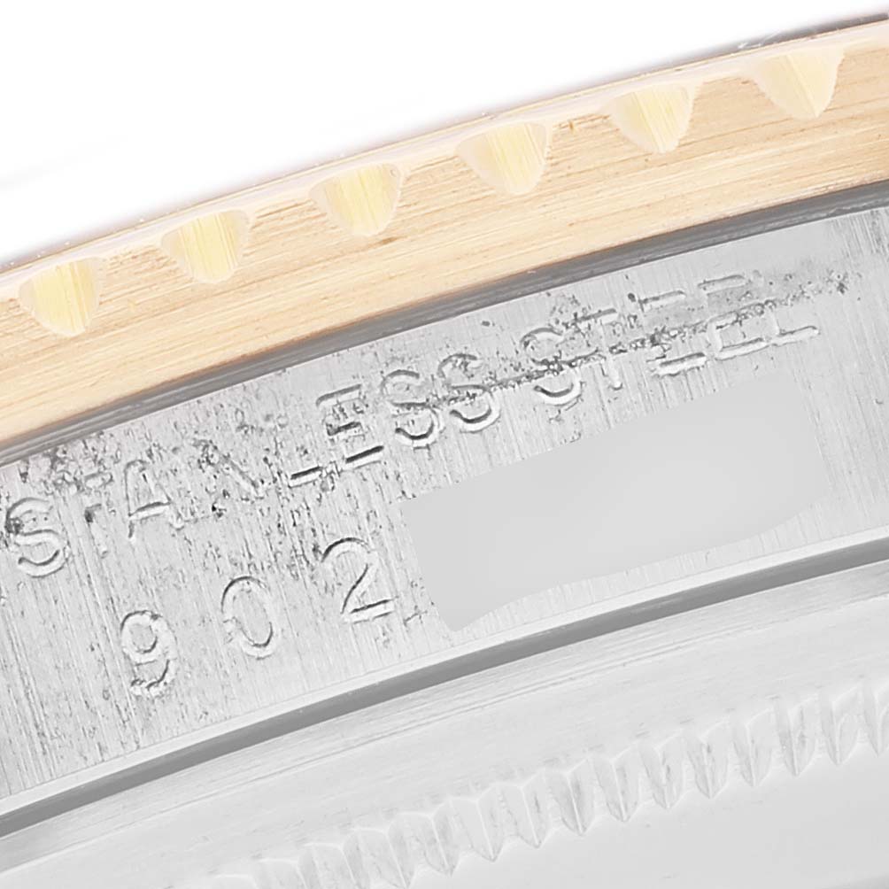 This image shows a close-up of the bezel and part of the stainless steel casing of a Vintage Collection model by Rolex.