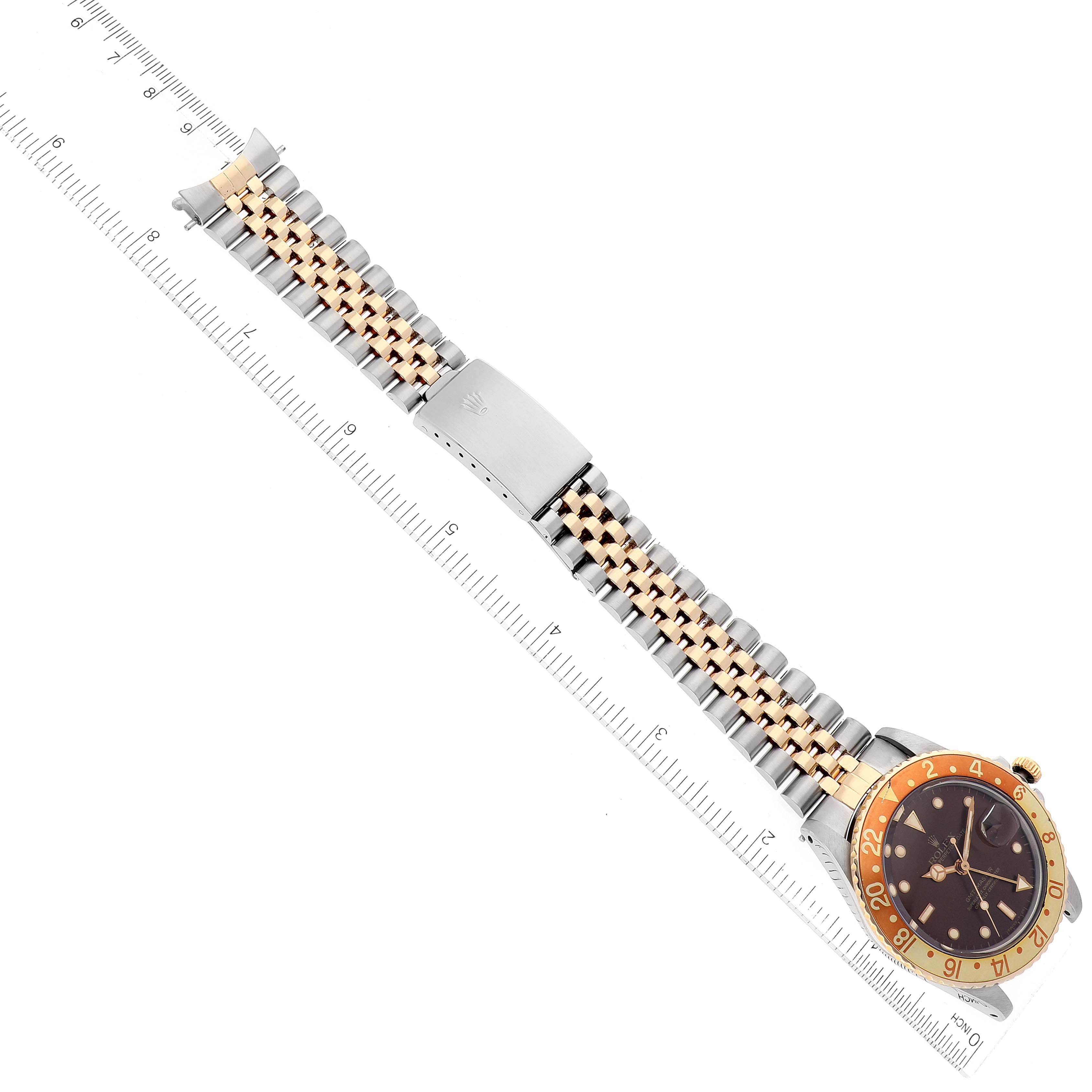 This image shows the Rolex Vintage Collection 16753 Men's Steel and Gold (two tone) Brown Dial 16753 Men's Steel and Gold (two tone) Brown Dial watch laid flat with its bracelet and clasp visible, next to a measurement ruler.