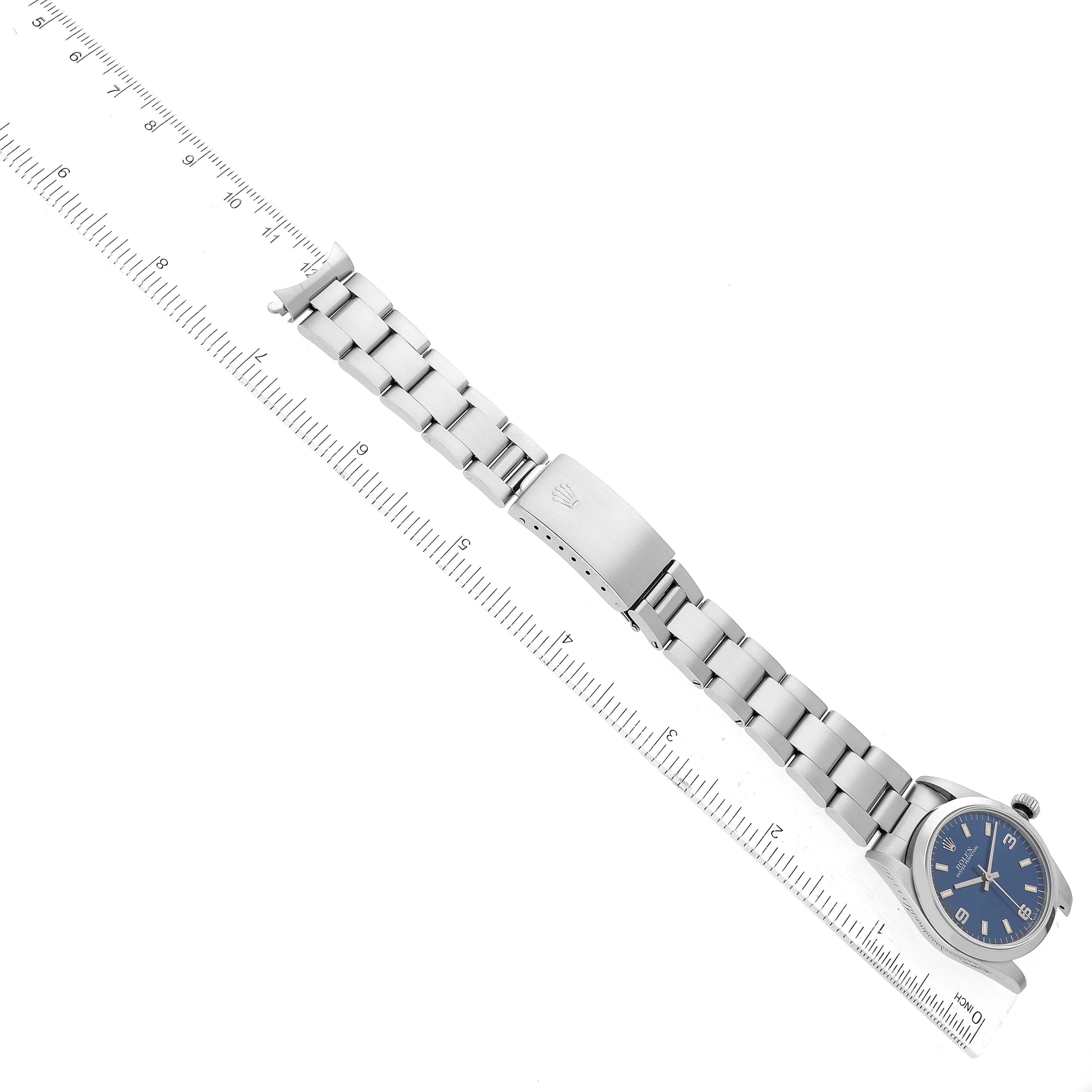 The image shows a Mid-Size Rolex watch laid flat with the bracelet extended next to a ruler for size reference.