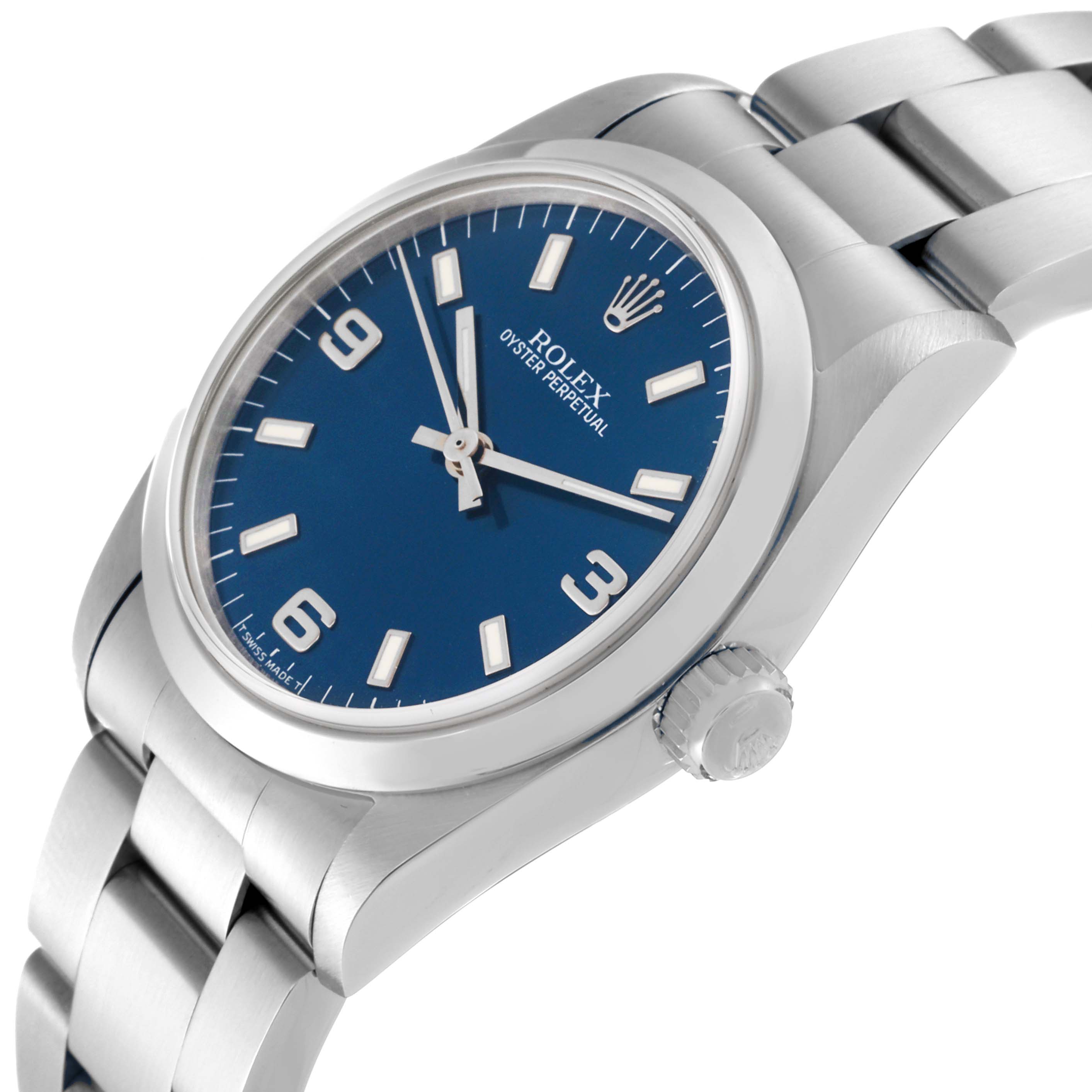 The image shows a Rolex Mid-Size 67480 Women
s Stainless Steel Blue Dial 67480 Women
s Stainless Steel Blue Dial Oyster Perpetual watch from a slight angle, highlighting the dial, case, and part of the bracelet.