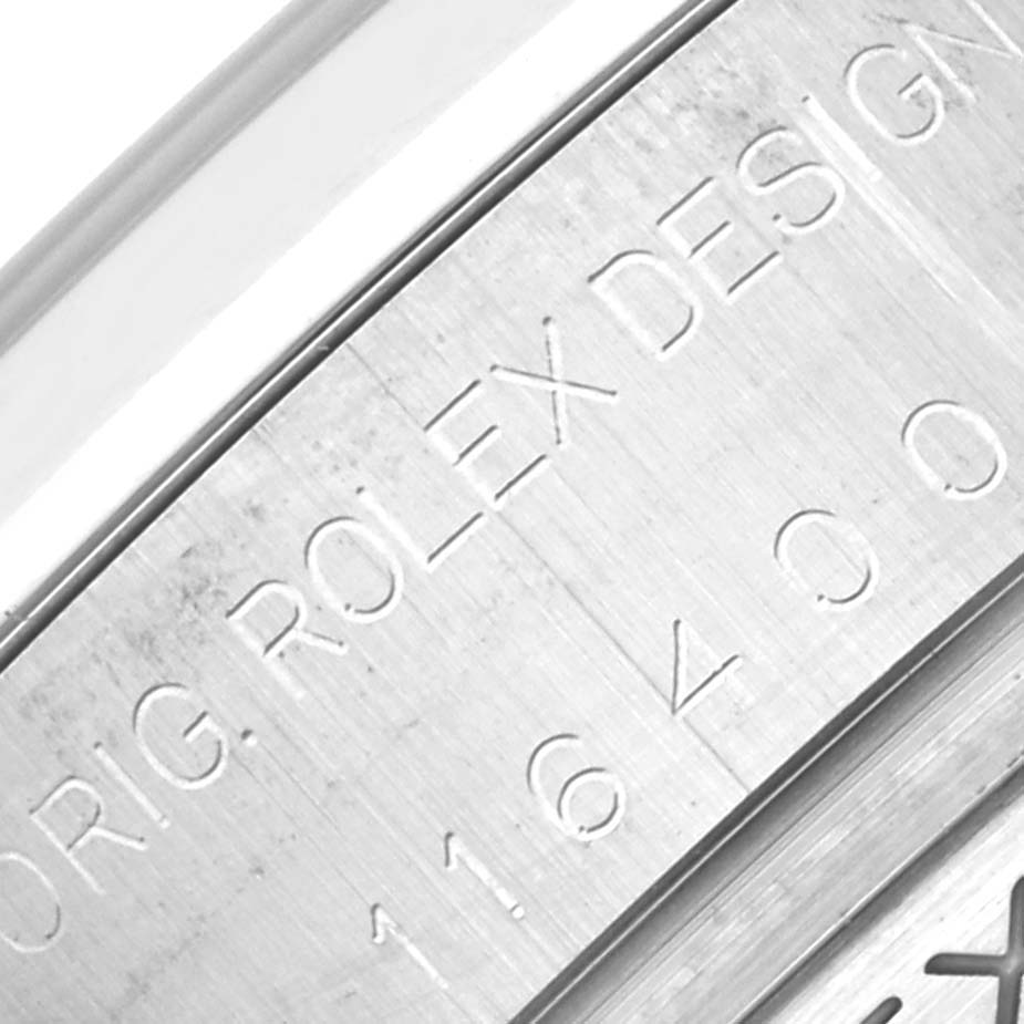 This close-up image shows the engraved serial and model numbers on the casing of a Rolex Milgauss 116400 Men
s Stainless Steel White Dial 116400 Men
s Stainless Steel White Dial watch.