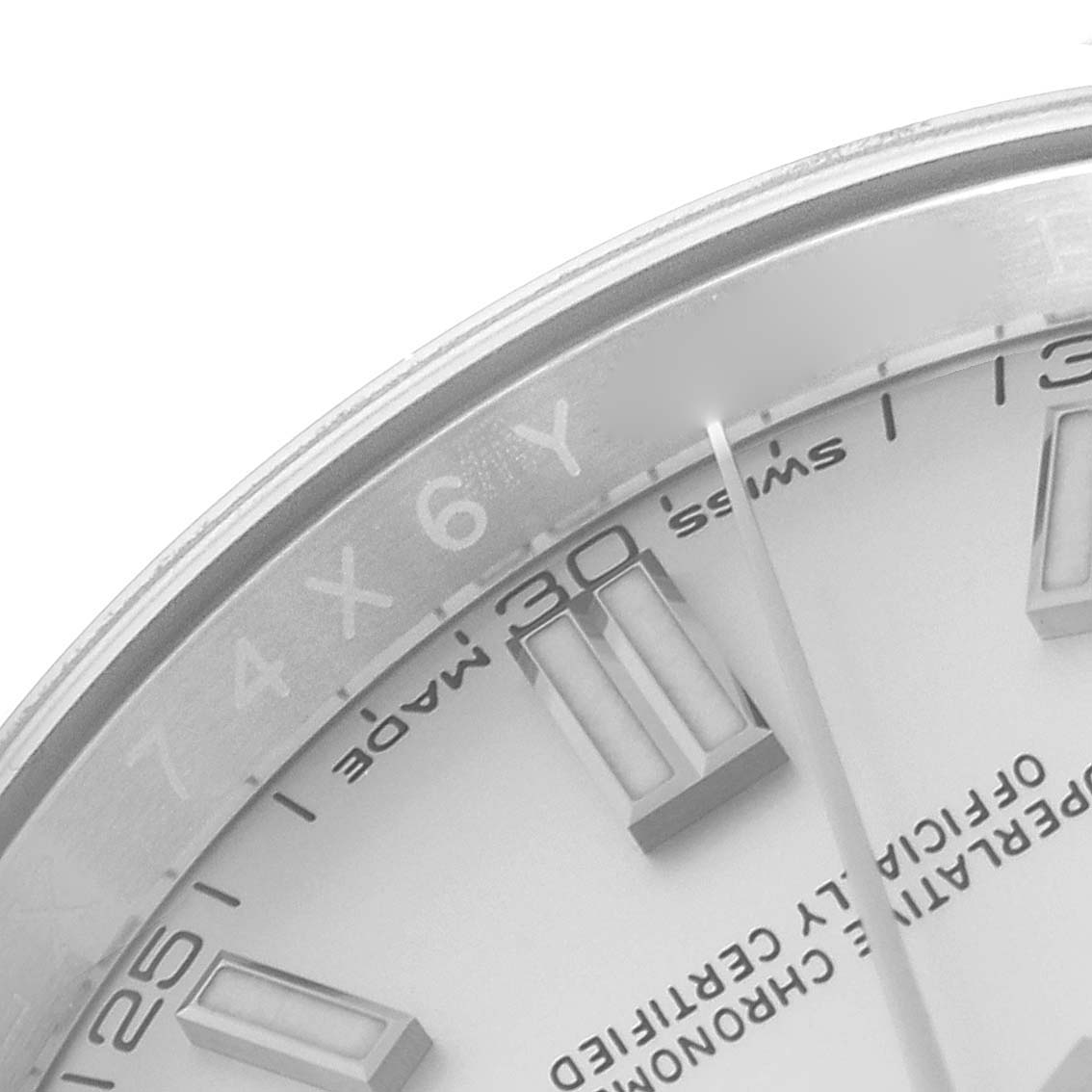 This image shows a close-up of the dial and part of the bezel of a Rolex Oyster Perpetual 62899 Men's Stainless Steel Silver Dial 62899 Men's Stainless Steel Silver Dial watch.