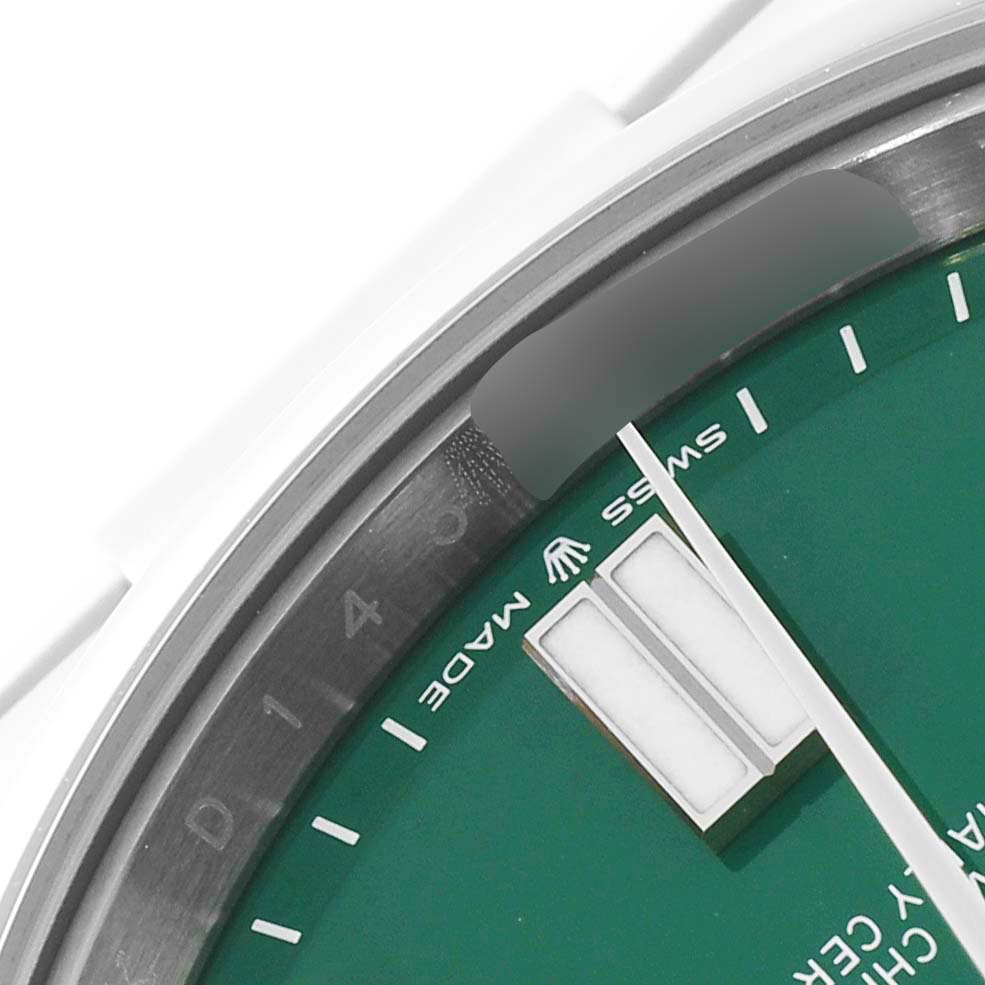The image shows a close-up of the dial and bezel of a Rolex Oyster Perpetual 124300 Men's Stainless Steel Green Dial 124300 Men's Stainless Steel Green Dial watch, with visible hour markers and the "Swiss Made" text.