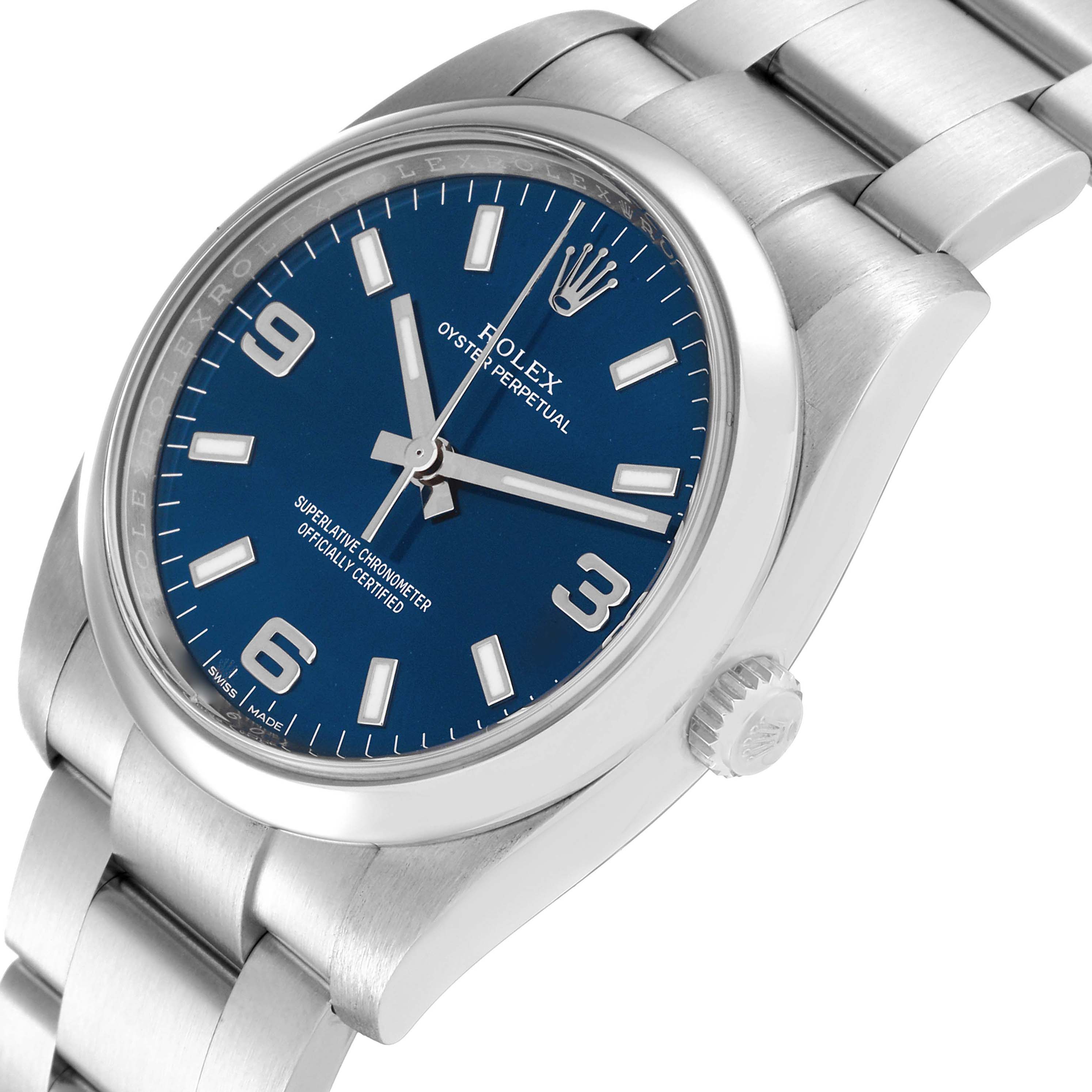 This image shows the face, crown, and band of a Rolex Oyster Perpetual 114200 Men's Stainless Steel Blue Dial 114200 Men's Stainless Steel Blue Dial watch from an angled top-side view.