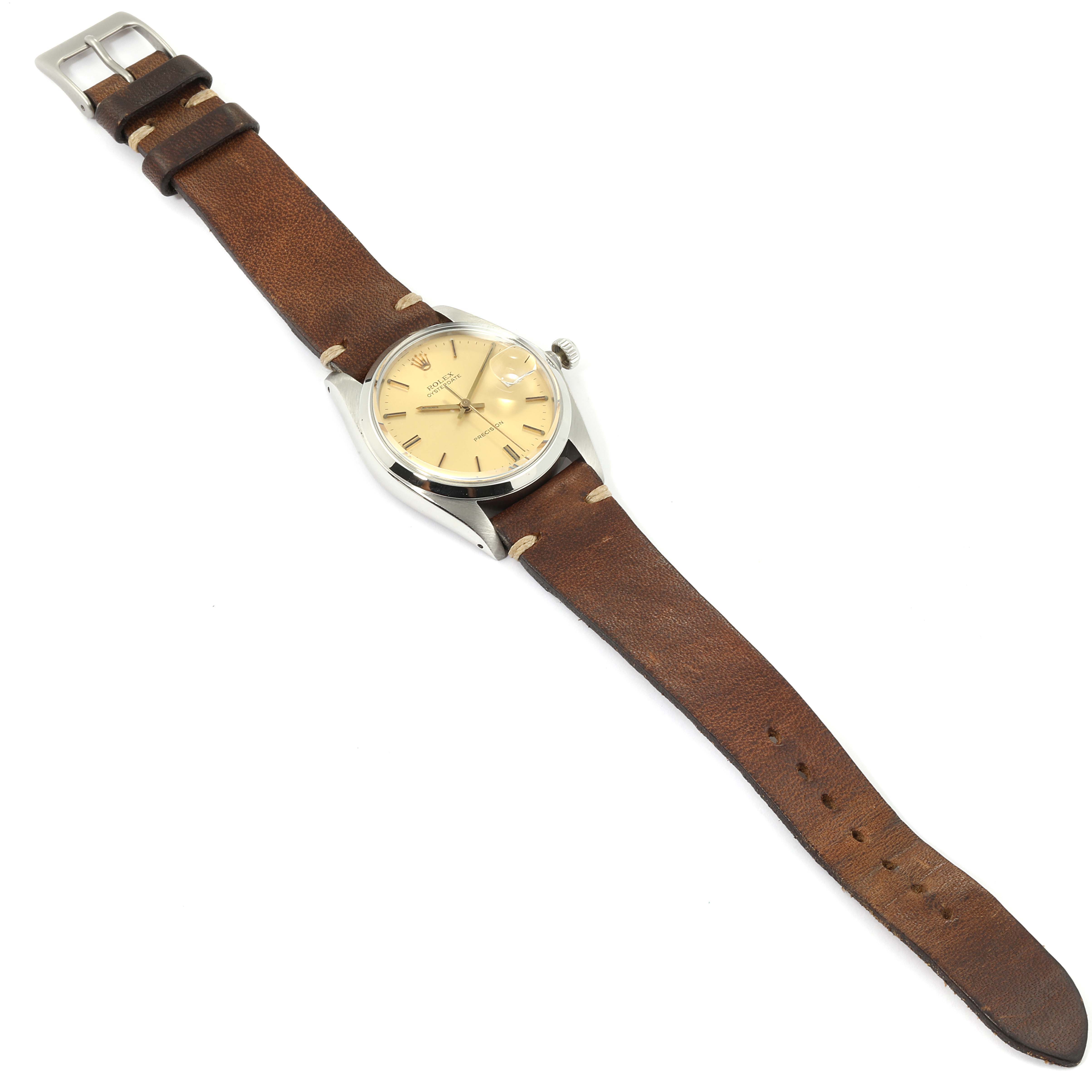 The image shows a side angle of a Rolex Vintage Collection 6694 Men's Stainless Steel Champagne Dial 6694 Men's Stainless Steel Champagne Dial watch with a brown leather strap.