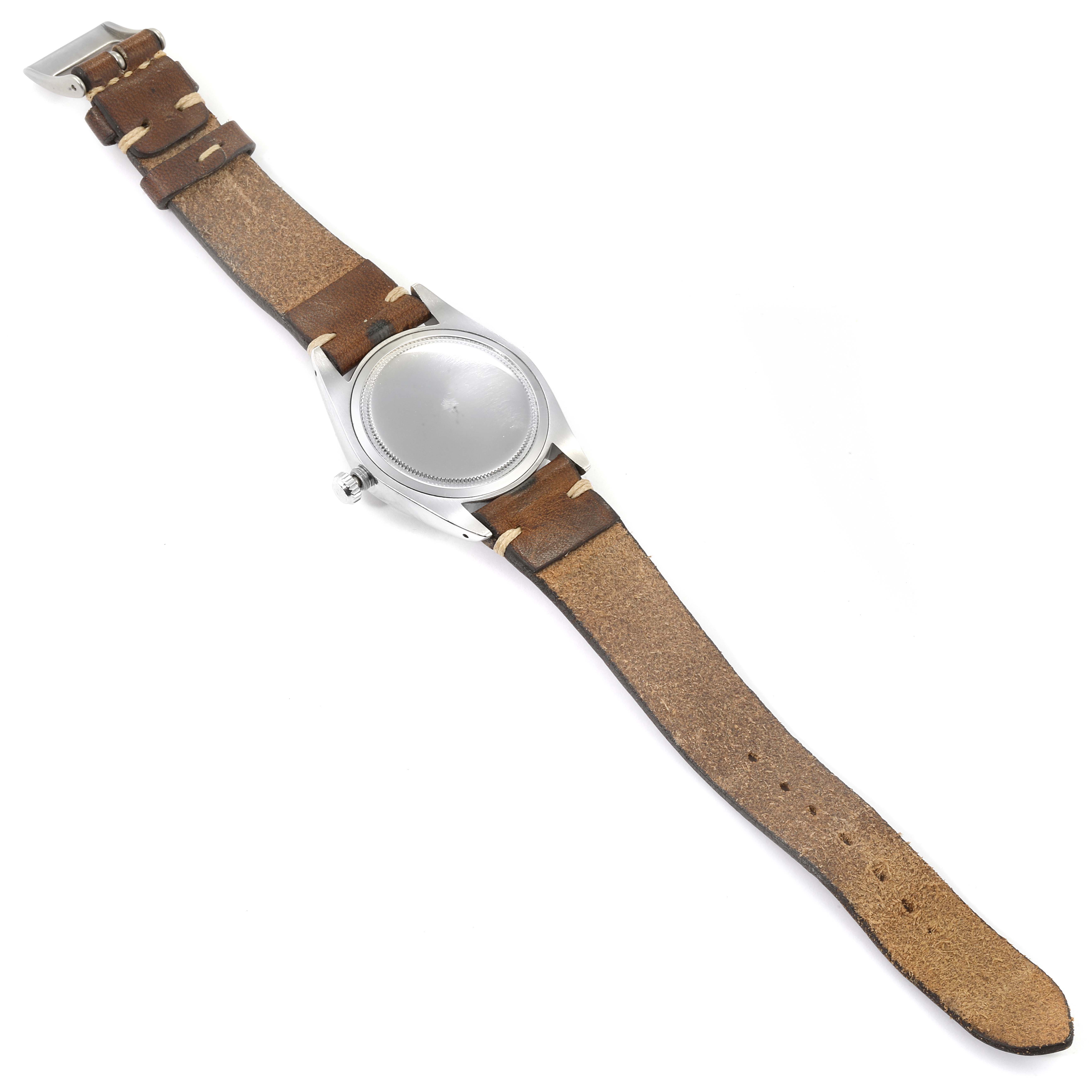 The image shows the back of the Vintage Collection model by Rolex, highlighting the case back and leather strap.