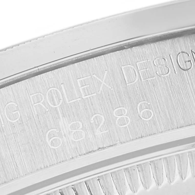 This image shows an engraved outer edge of the back case of a Rolex President 68286 Women's Platinum Silver Dial 68286 Women's Platinum Silver Dial model watch.