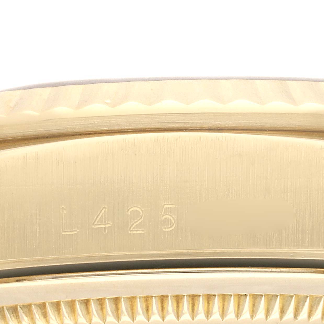 This close-up view of the Rolex President 18238 Men's Yellow Gold White Dial 18238 Men's Yellow Gold White Dial watch shows the side of the gold case with engraved serial numbers.
