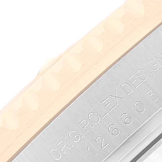 The image shows a close-up of the bezel and part of the engraved case of a Rolex Sea-Dweller 126603 Men's Steel and Gold (two tone) Black Dial 126603 Men's Steel and Gold (two tone) Black Dial watch.