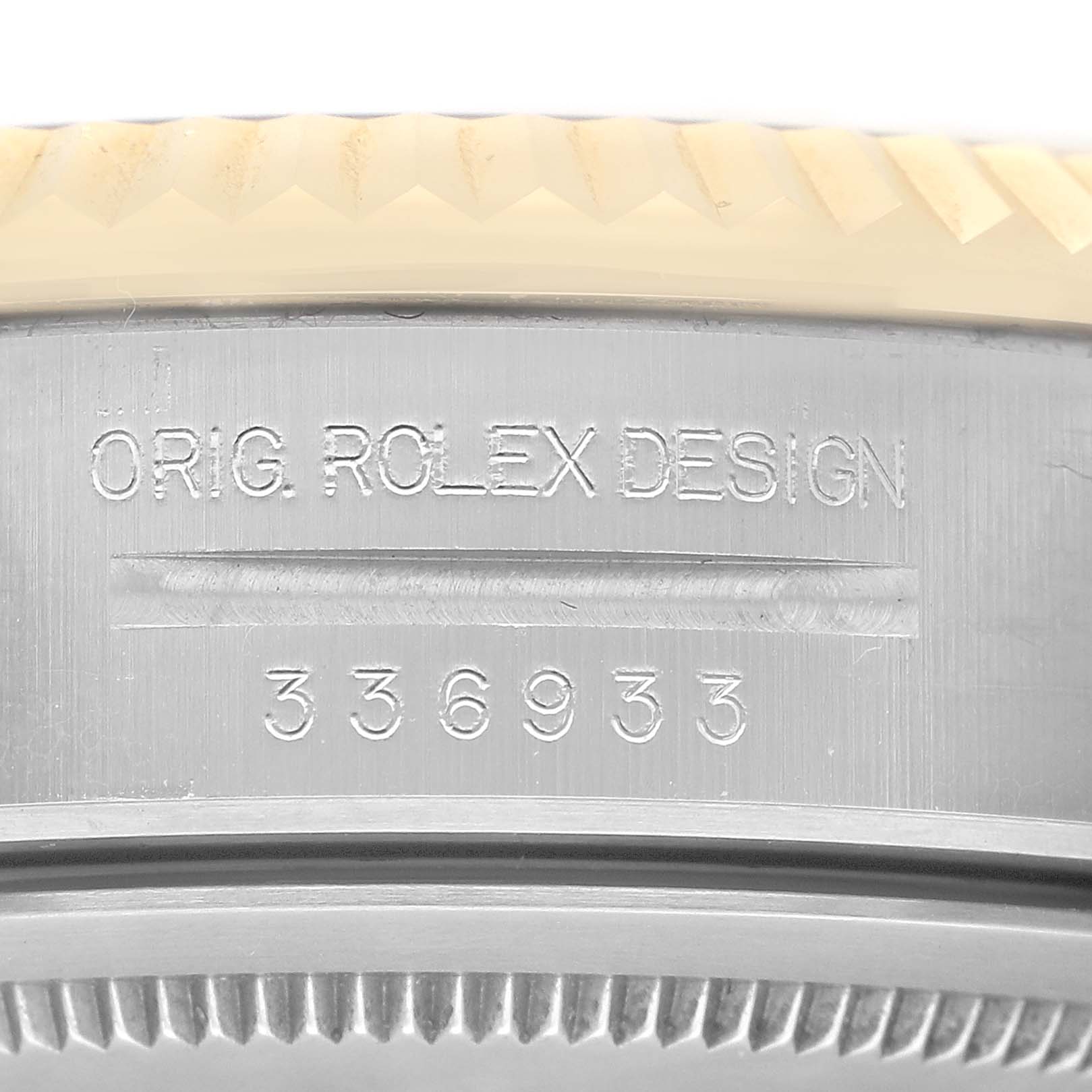 The image shows a close-up of the engraved bezel and case back of a Rolex Sky-Dweller 336933 Men's Steel and Gold (two tone) Champagne Dial.