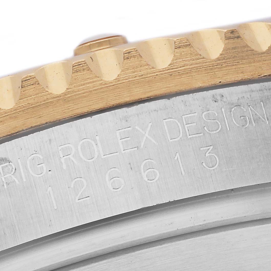 The image shows a close-up of the bezel and case number engraving on a Rolex Submariner 126613 Men's Steel and Gold (two tone) Blue Dial 126613 Men's Steel and Gold (two tone) Blue Dial.