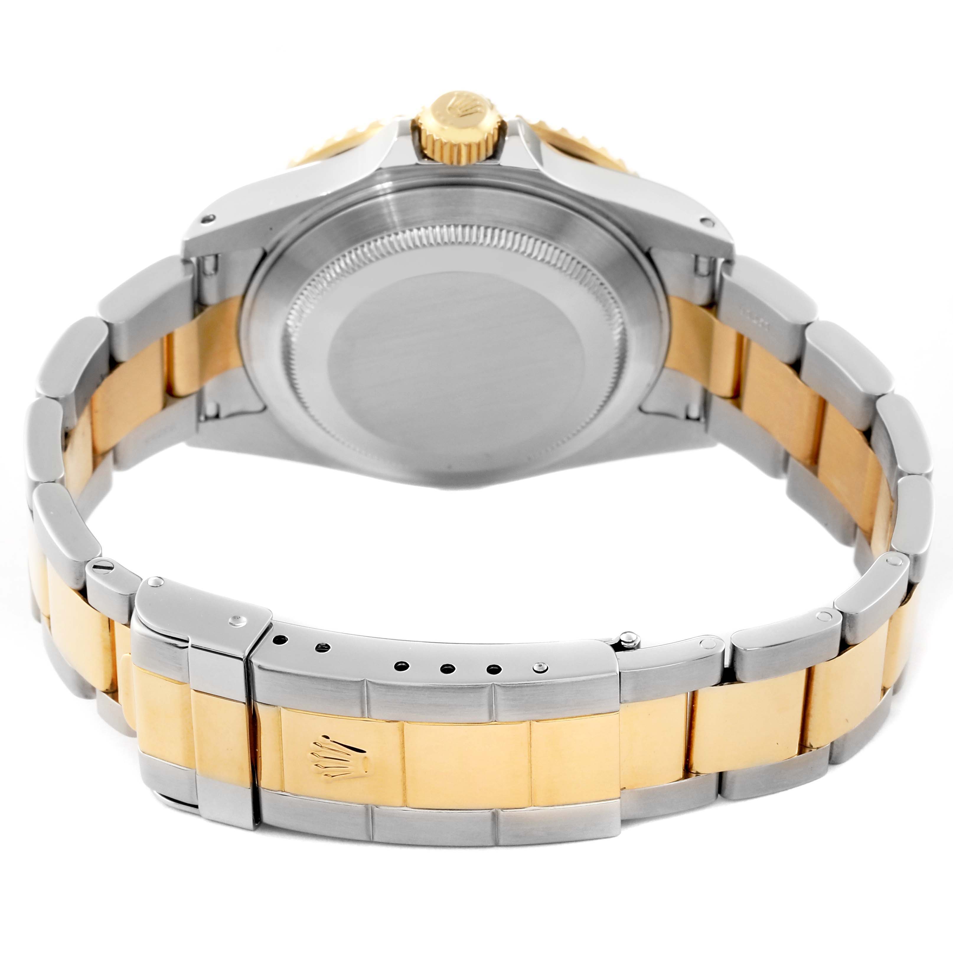 The image shows the back view of a Rolex Submariner 16613 Men's Steel and Gold (two tone) Champagne Dial 16613 Men's Steel and Gold (two tone) Champagne Dial watch, focus on the case back and two-tone bracelet.