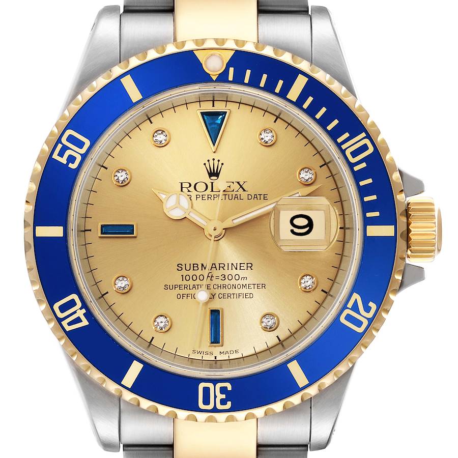 This image shows a frontal view of the Rolex Submariner watch, highlighting the gold dial, blue bezel, date window, and two-tone bracelet.