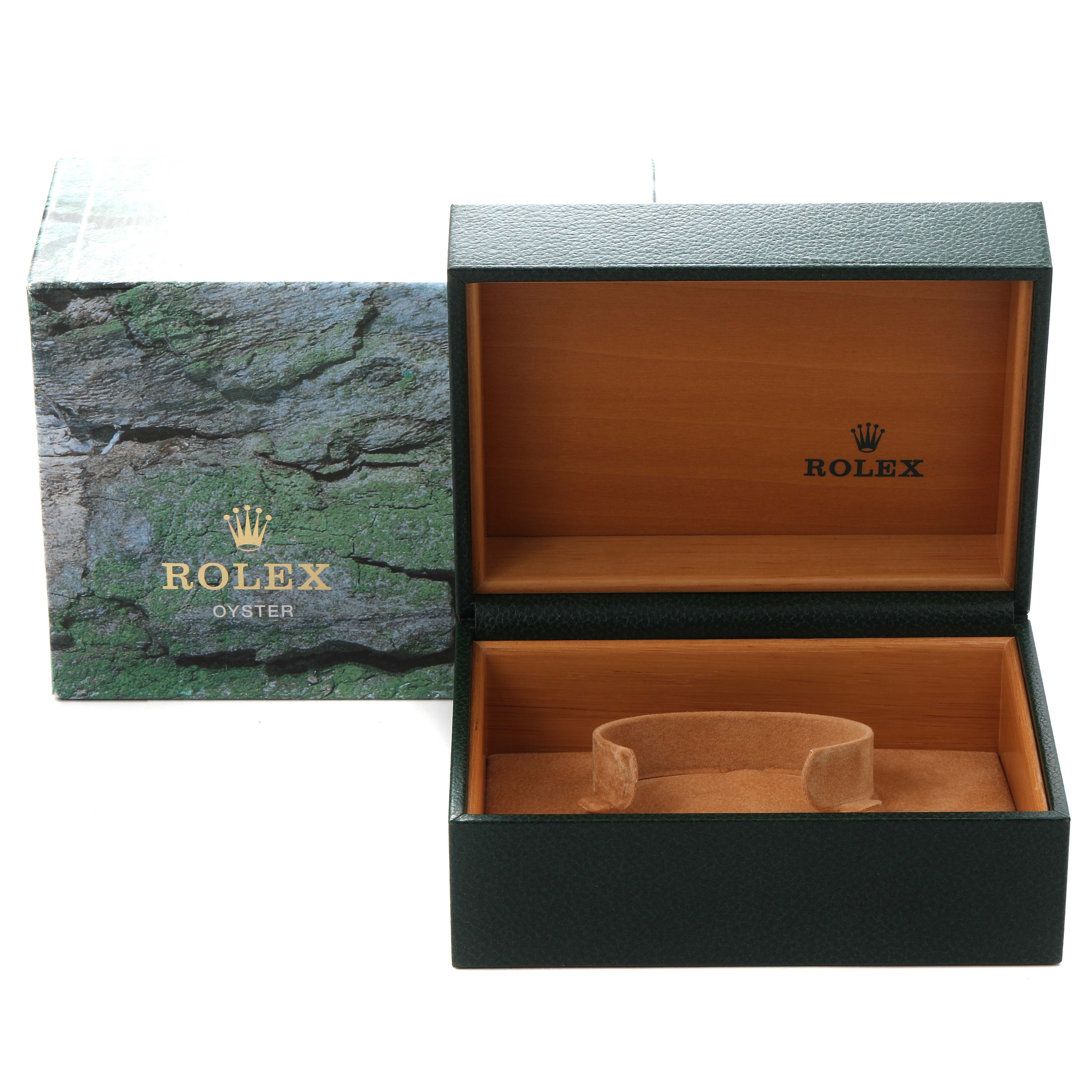 This image shows an open Rolex watch box for a Submariner model, alongside its outer packaging.