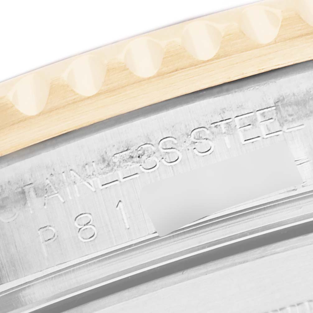 The image shows a close-up of the Rolex Submariner 16613 Men
s Steel and Gold (two tone) Champagne Dial 16613 Men
s Steel and Gold (two tone) Champagne Dial
s case side, highlighting the bezel and engraved stainless steel text.