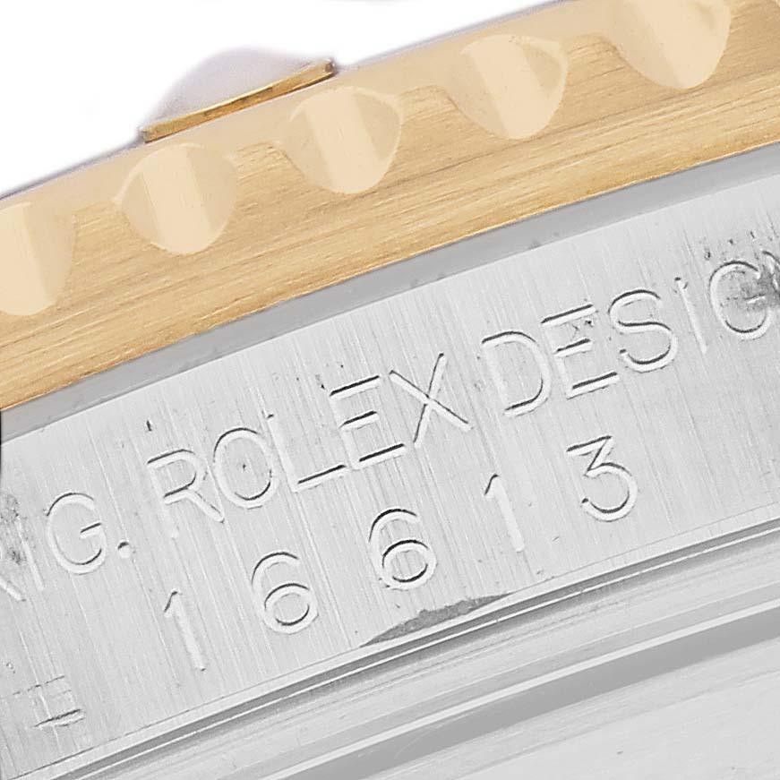 The image shows a close-up of the Rolex Submariner 16613 Men
s Steel and Gold (two tone) Champagne Dial 16613 Men
s Steel and Gold (two tone) Champagne Dial
s engraved side and bezel edge, highlighting the model number.