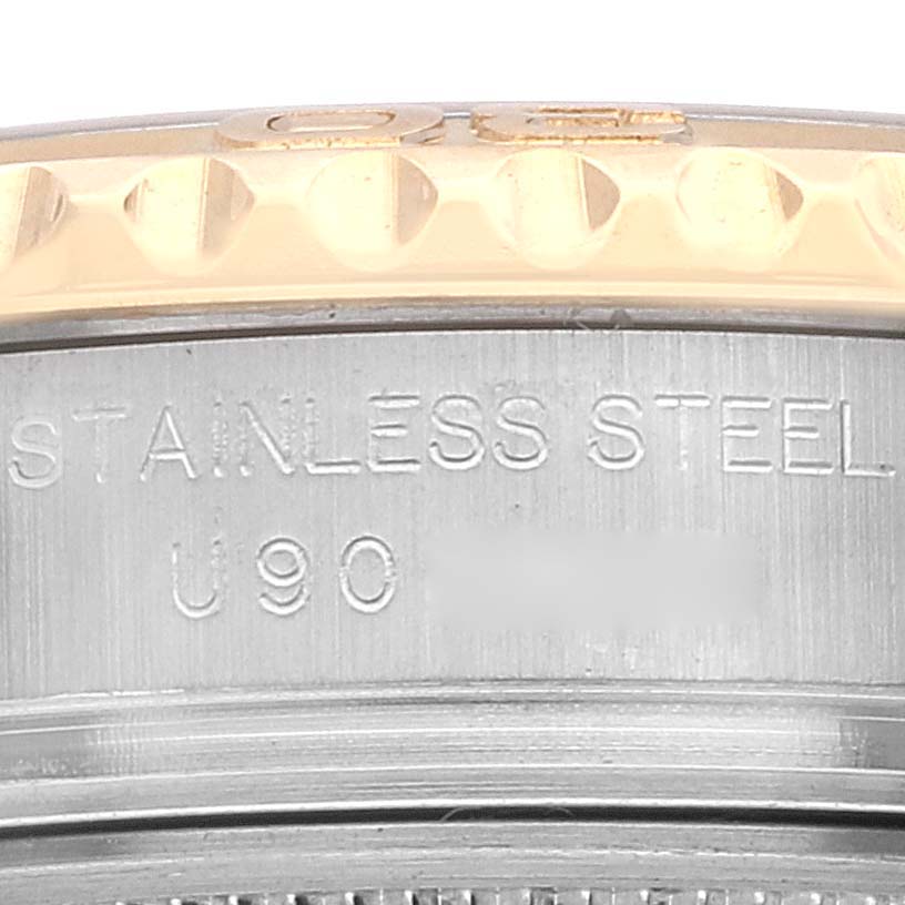 This close-up image shows the side of a Rolex Yacht-Master 69623 Women's Steel and Gold (two tone) White Dial 69623 Women's Steel and Gold (two tone) White Dial watch, featuring part of the stainless steel case and bezel.