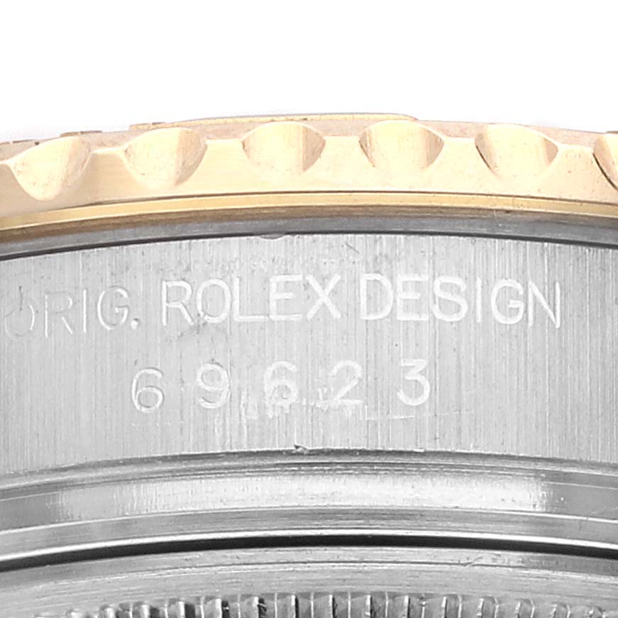 The image shows a close-up of the case side with engraving on a Rolex Yacht-Master 69623 Women's Steel and Gold (two tone) White Dial 69623 Women's Steel and Gold (two tone) White Dial watch.