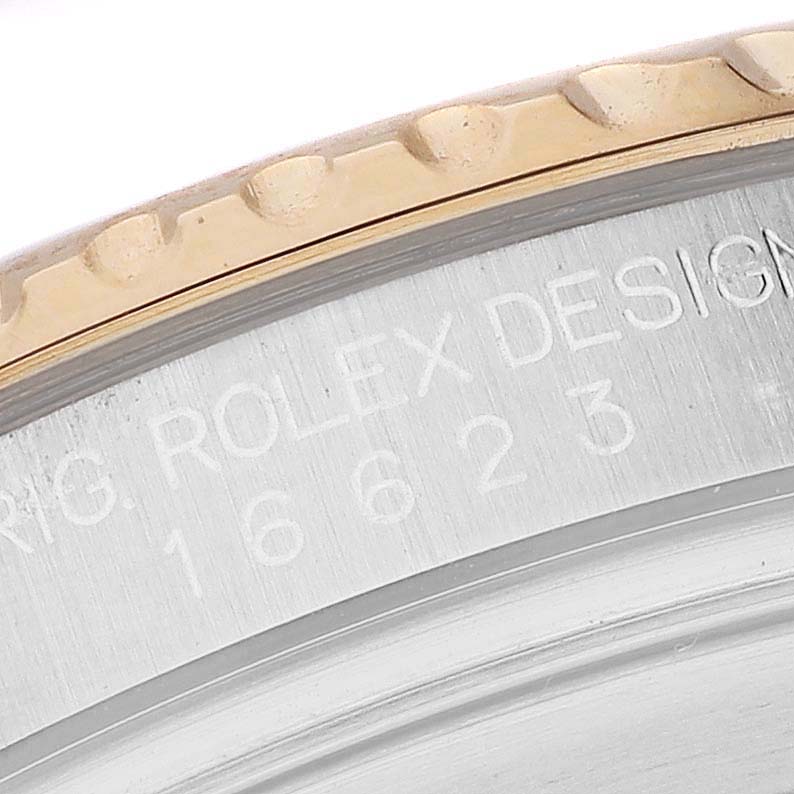 The image shows a close-up of the engraving on the bezel edge of a Rolex Yacht-Master 16623 Men's Steel and Gold (two tone) Blue Dial watch.