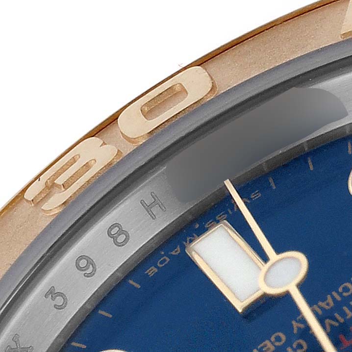 The image shows a close-up of the bezel and dial of a Rolex Yacht-Master 16623 Men's Steel and Gold (two tone) Blue Dial watch, highlighting hour markers and numerals.