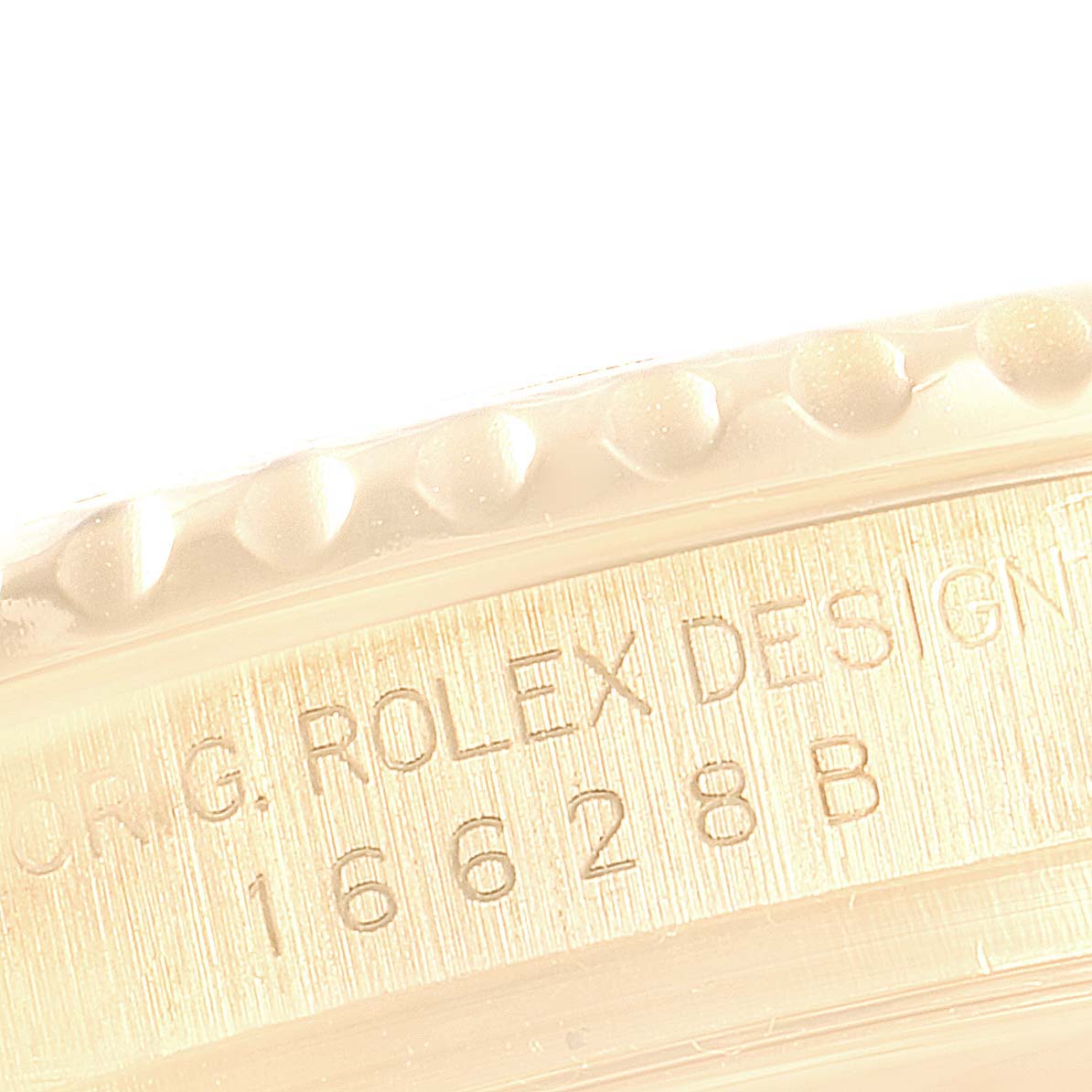 Close-up angle showing the engraved text and part of the bezel of the Rolex Yacht-Master 16628 Men's Yellow Gold White Dial 16628 Men's Yellow Gold White Dial model.