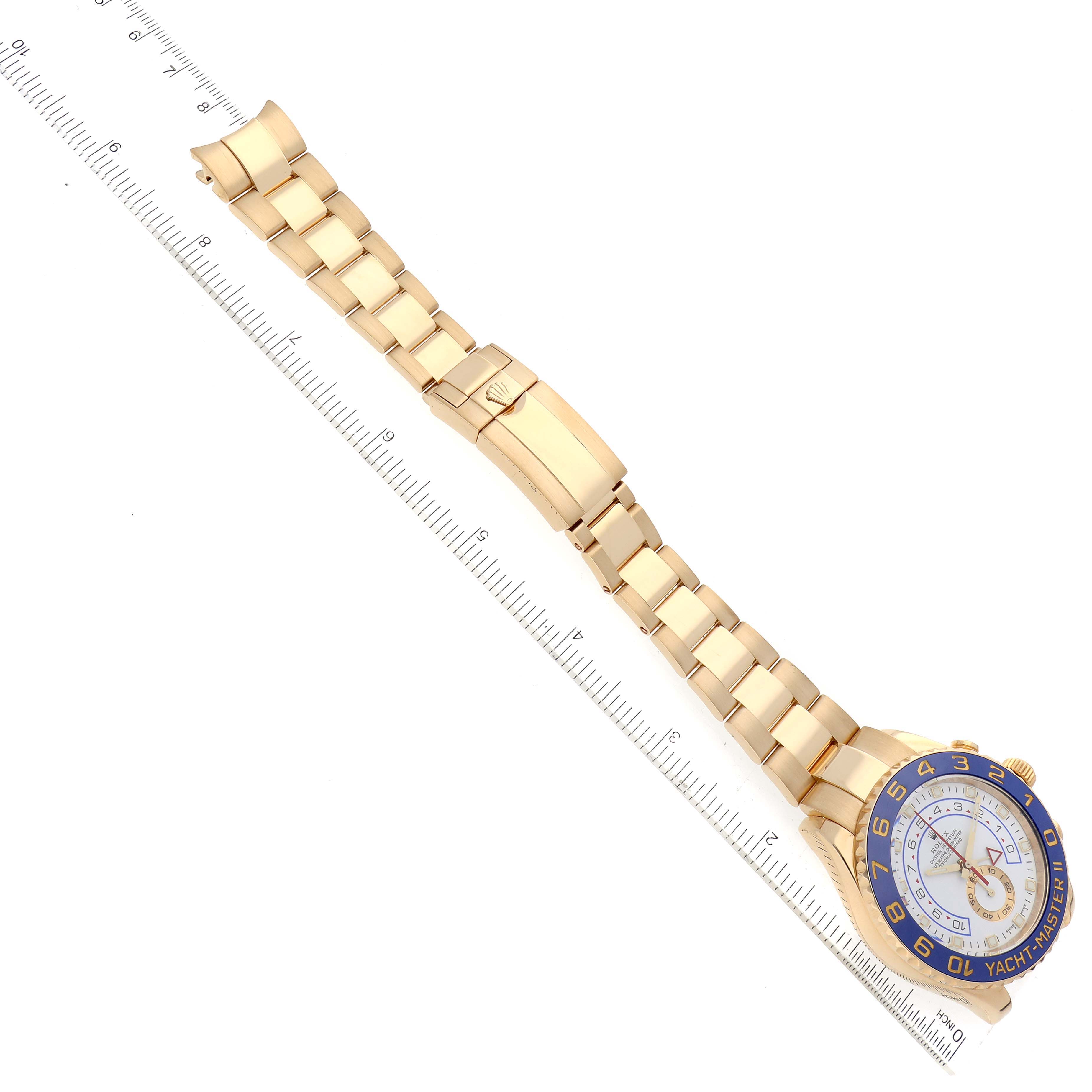 The image shows a side view of a Rolex Yacht-Master 116688 Men's Yellow Gold White Dial 116688 Men's Yellow Gold White Dial watch, including the bracelet, clasp, and part of the watch face with a ruler for scale.