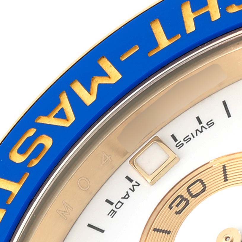 Close-up of the dial and bezel of a Rolex Yacht-Master 116688 Men's Yellow Gold White Dial 116688 Men's Yellow Gold White Dial watch, showing part of the blue bezel with yellow text and a date window.