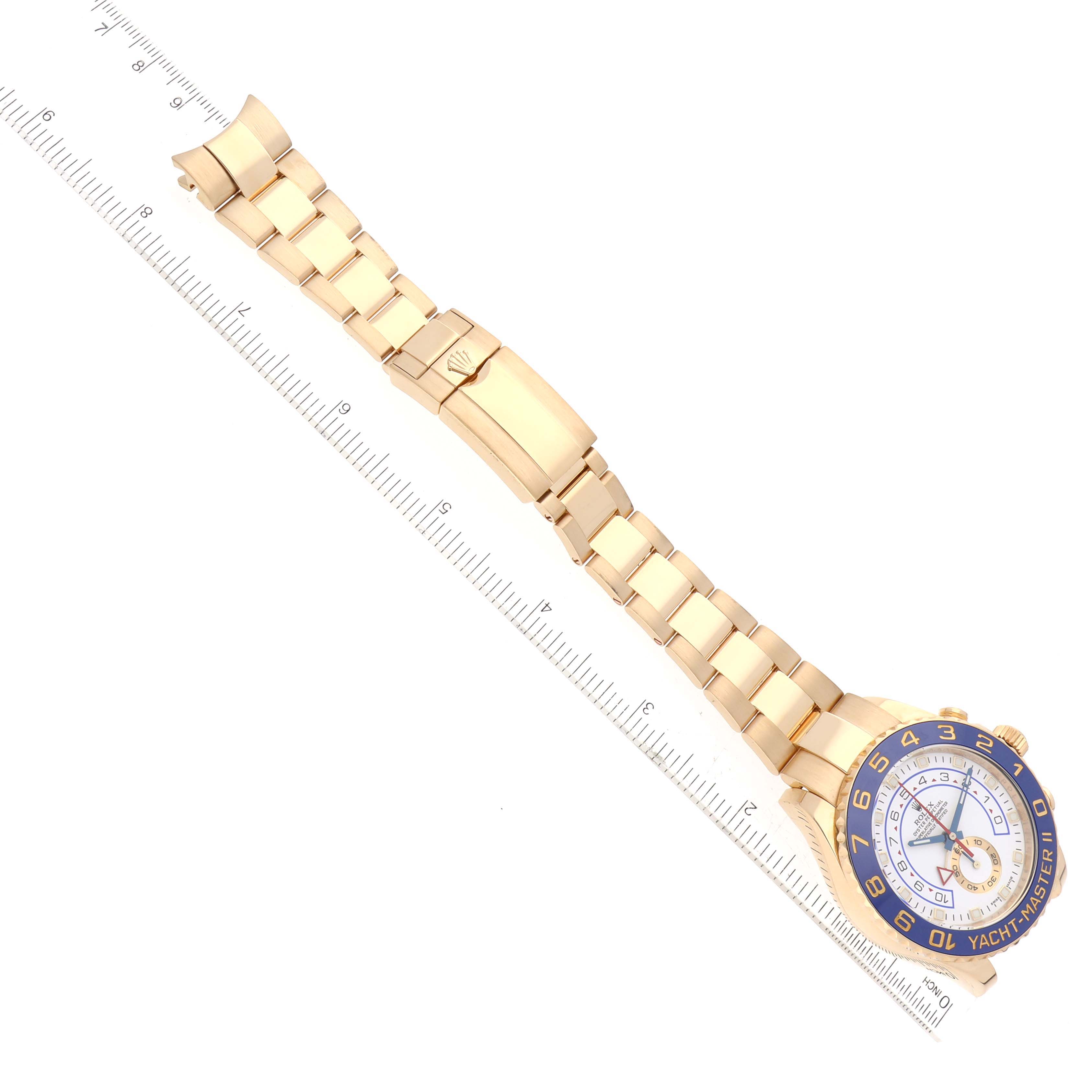 The image shows a top-down view of a Rolex Yacht-Master 116688 Men's Yellow Gold White Dial 116688 Men's Yellow Gold White Dial watch, displaying the face, strap, and clasp aligned next to a ruler for scale.