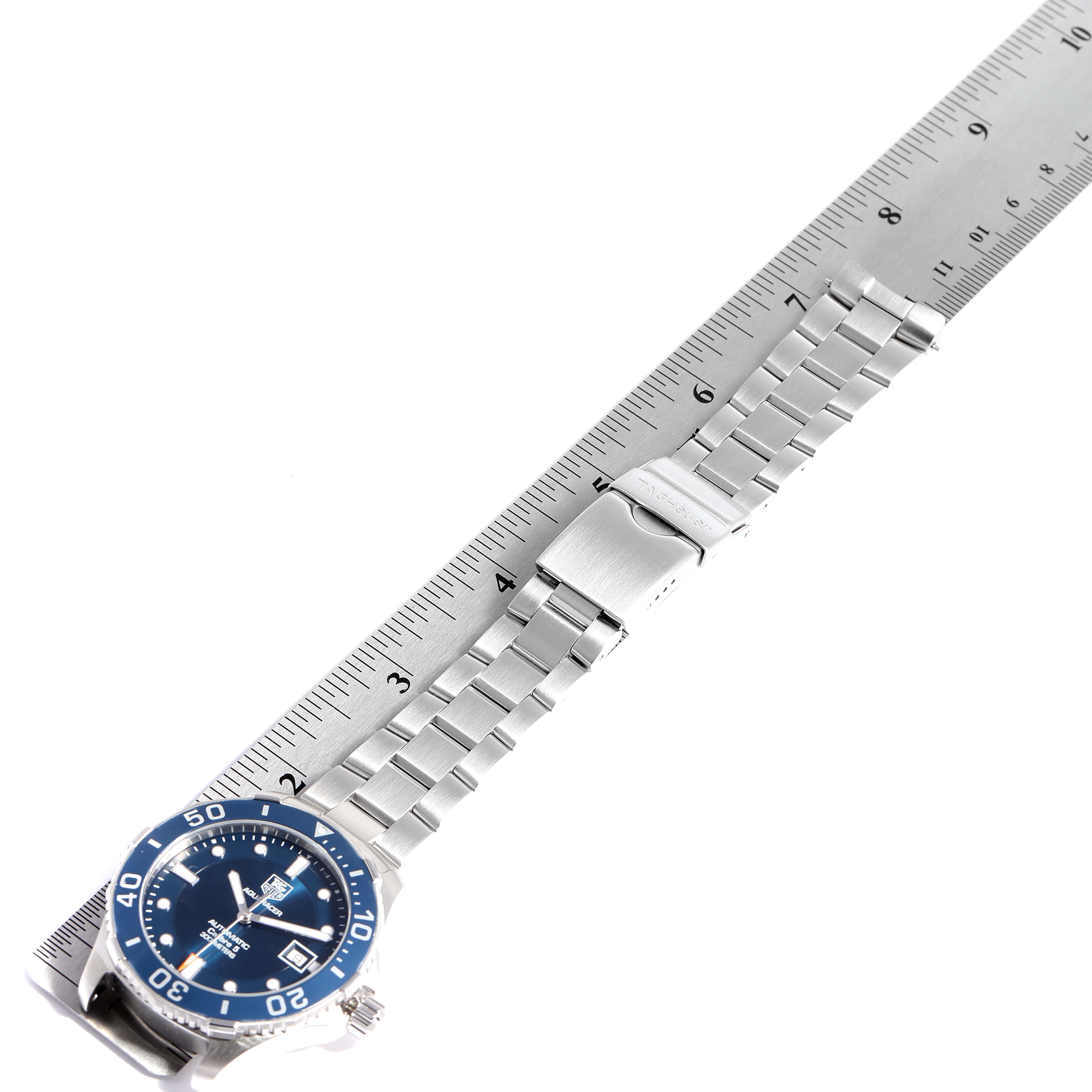 The image shows the Tag Heuer Aquaracer WAN2111.BA0822 Men's Stainless Steel Blue Dial WAN2111.BA0822 Men's Stainless Steel Blue Dial watch lying flat, highlighting the face, bezel, and metal bracelet with a ruler beside it.
