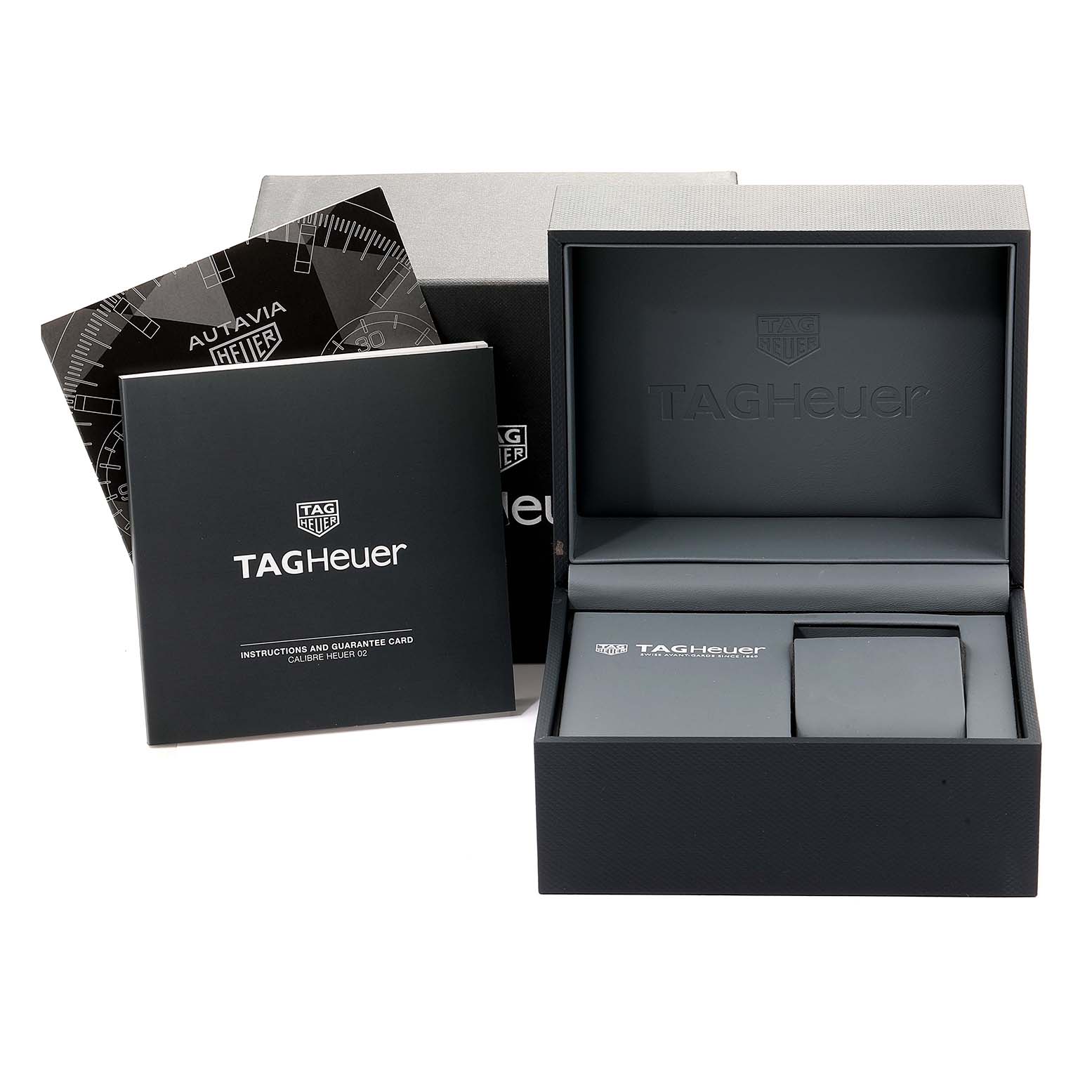 The image shows a Tag Heuer Autavia CBE2110.BA0687 Men's Stainless Steel Black Dial CBE2110.BA0687 Men's Stainless Steel Black Dial watch box, an open case, and instruction booklets at a front angle.