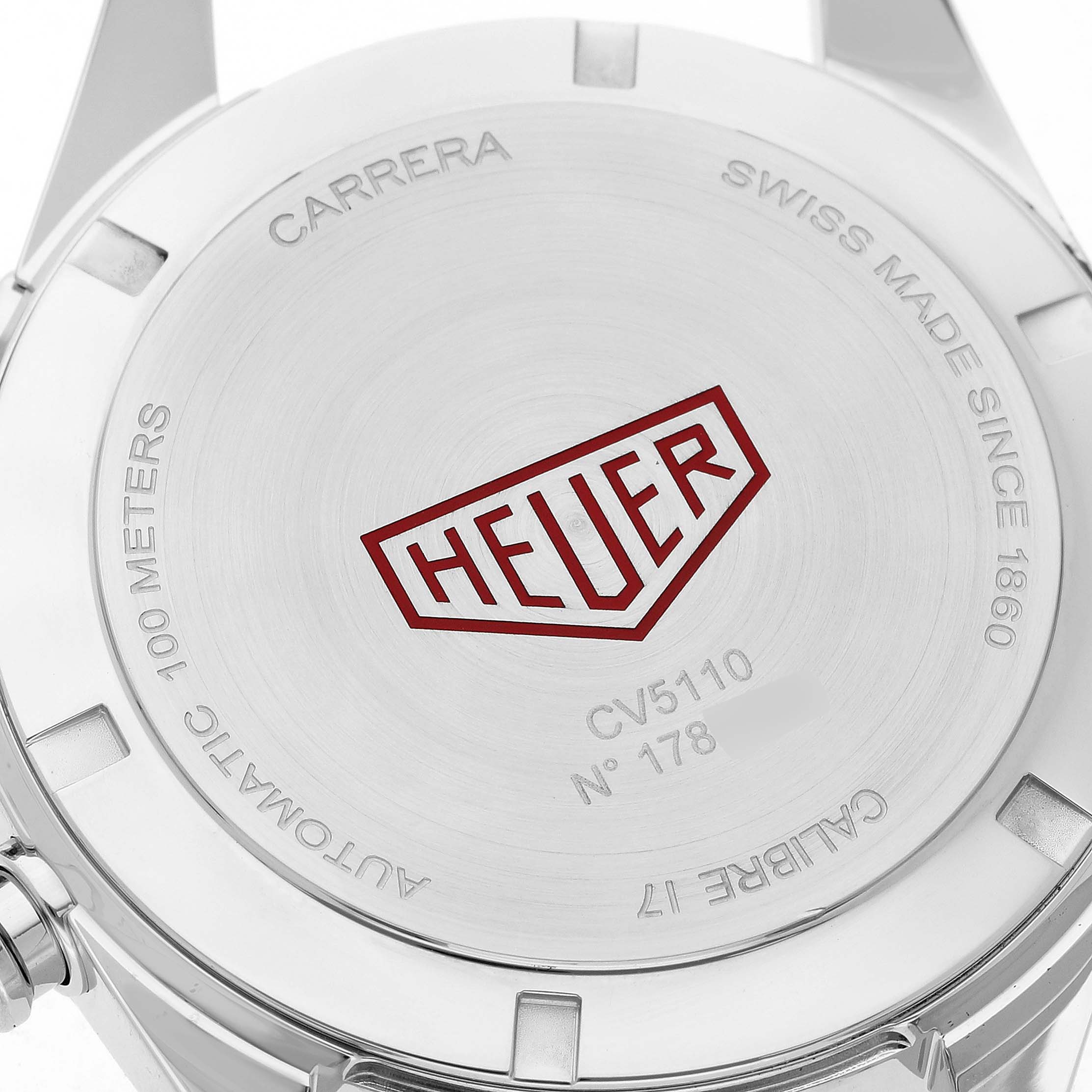 The image shows the back of a Tag Heuer Carrera CV5110.FC6310 Men's Stainless Steel Grey Dial watch, highlighting the engraved logo and specifications.