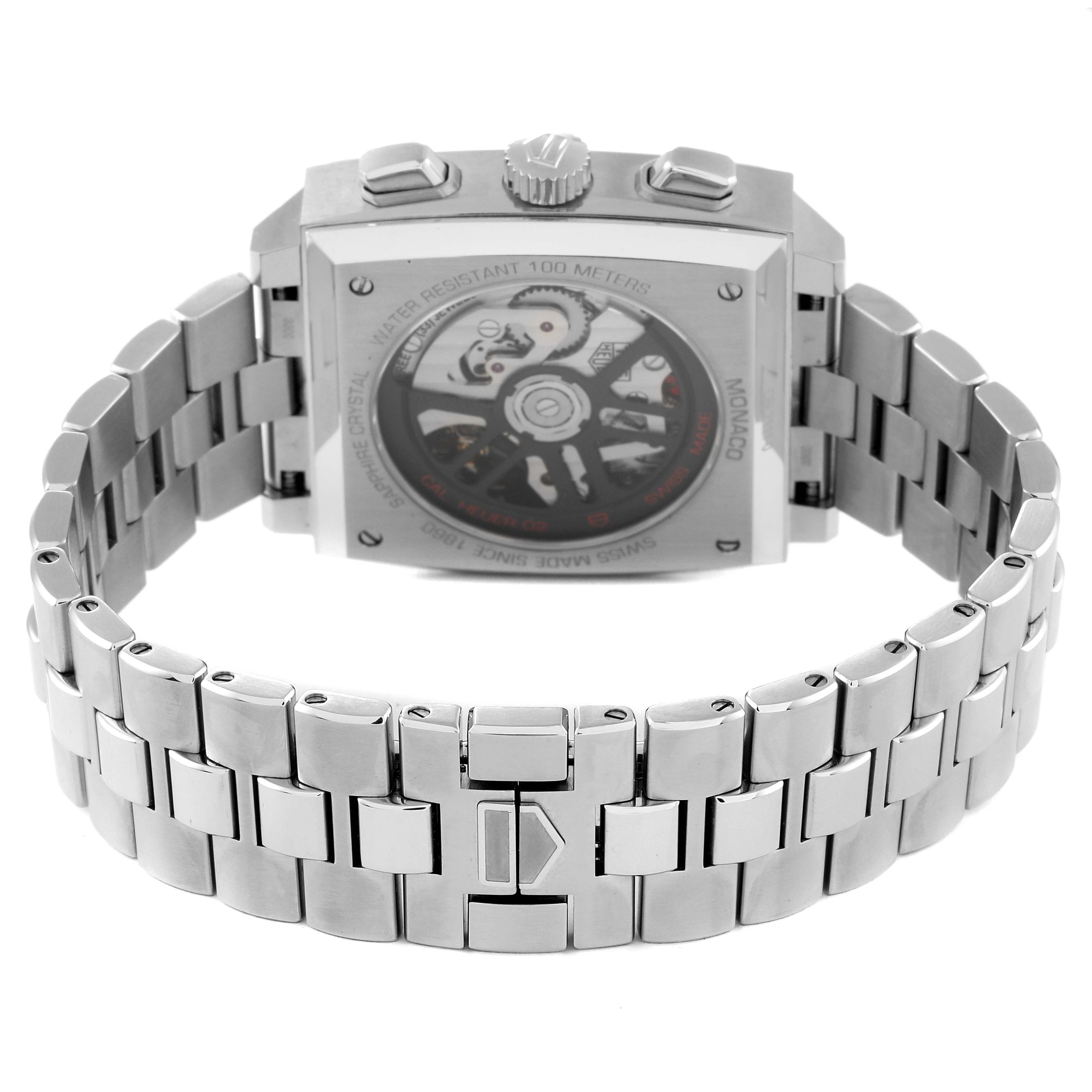 The image shows the back angle of the Tag Heuer Monaco CBL2111.FC6453 Men's Stainless Steel Blue Dial CBL2111.FC6453 Men's Stainless Steel Blue Dial watch, highlighting its transparent case back and stainless steel bracelet.