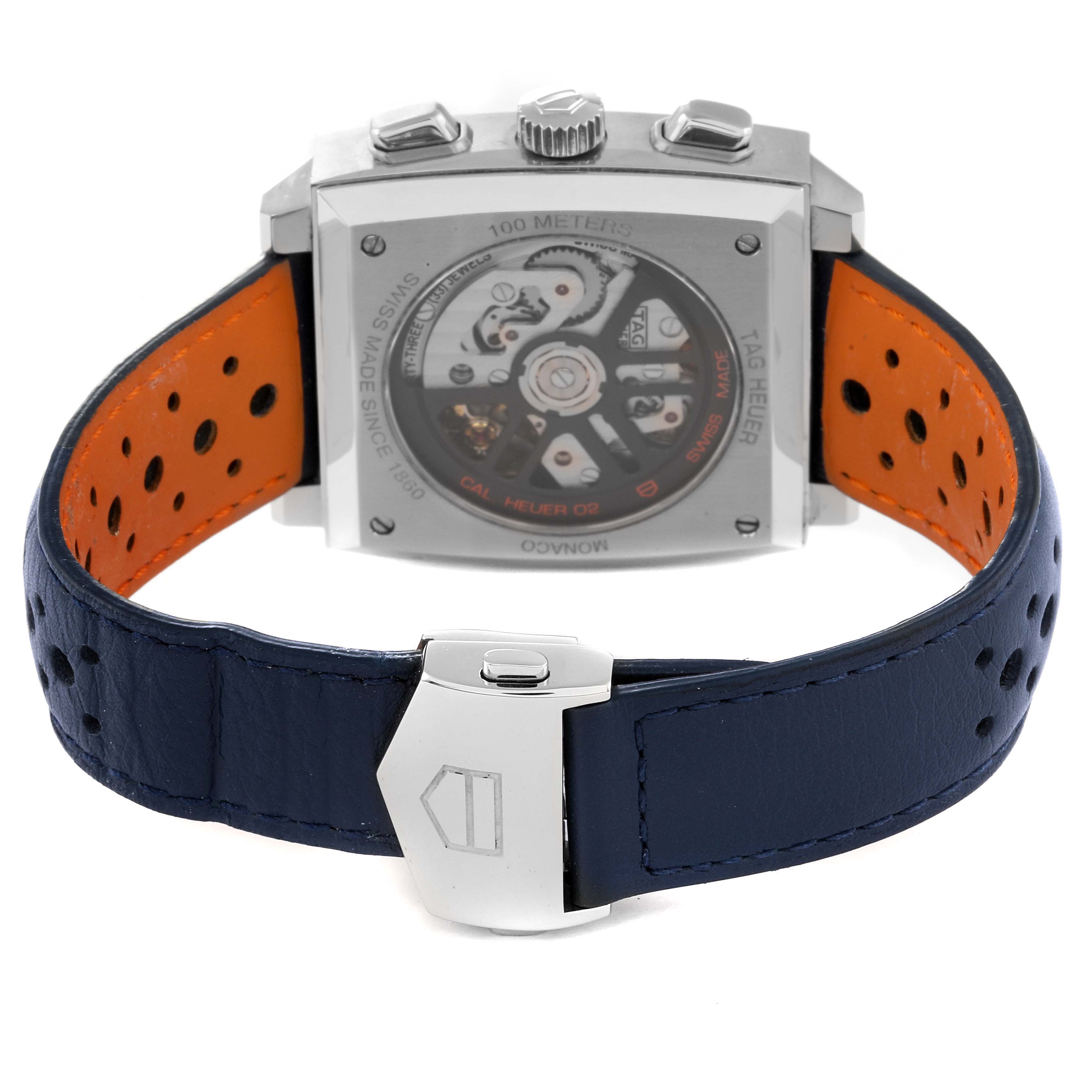 The image shows the back view of a Tag Heuer Monaco CBL2115.FC6494 Men's Stainless Steel Blue Dial CBL2115.FC6494 Men's Stainless Steel Blue Dial watch, focusing on the movement and blue leather strap with an orange interior.