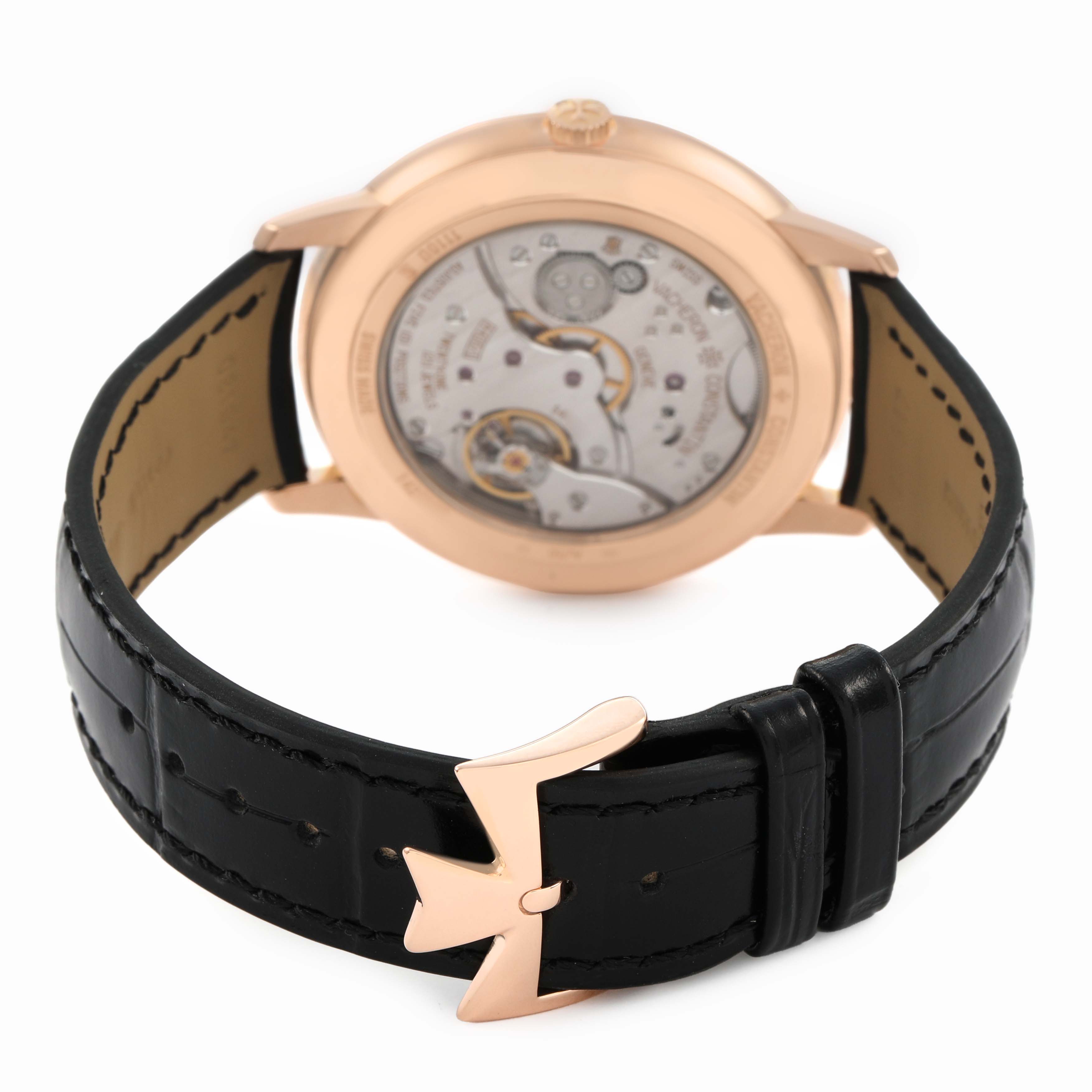 The Vacheron Constantin Patrimony 1110U/000R Men's Rose Gold Silver Dial watch is shown from the back, highlighting its open case back mechanism and black leather strap with clasp.