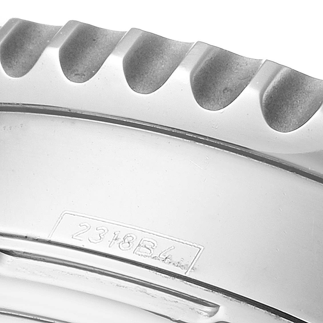 The image shows a close-up of the engraved bezel of a Breitling Navitimer AB0121 Men
s Stainless Steel Black Dial AB0121 Men
s Stainless Steel Black Dial watch, with part of its serial number visible.