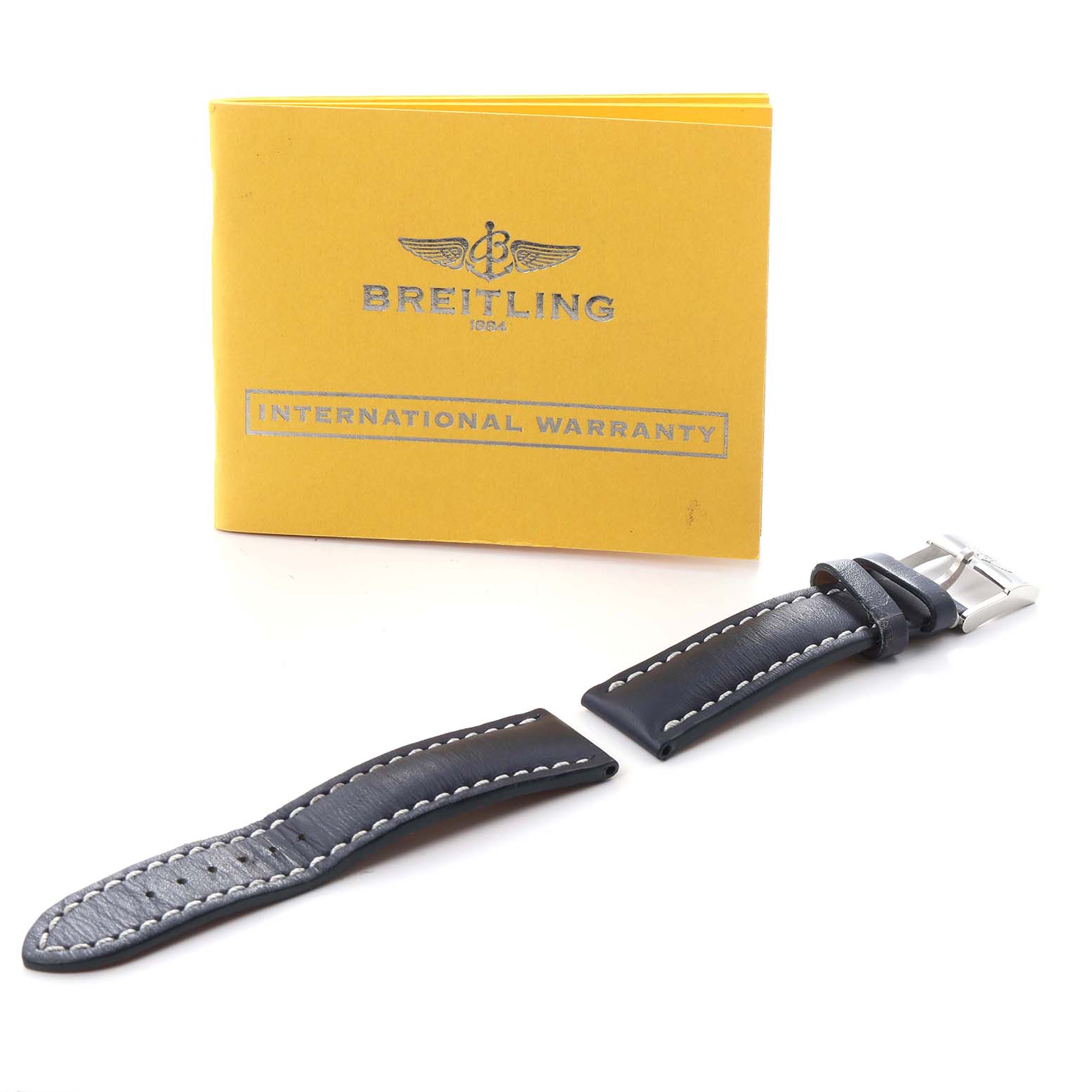 The image shows a Breitling Navitimer A13330 Men
s Stainless Steel Black Dial A13330 Men
s Stainless Steel Black Dial strap and buckle, along with an international warranty booklet.