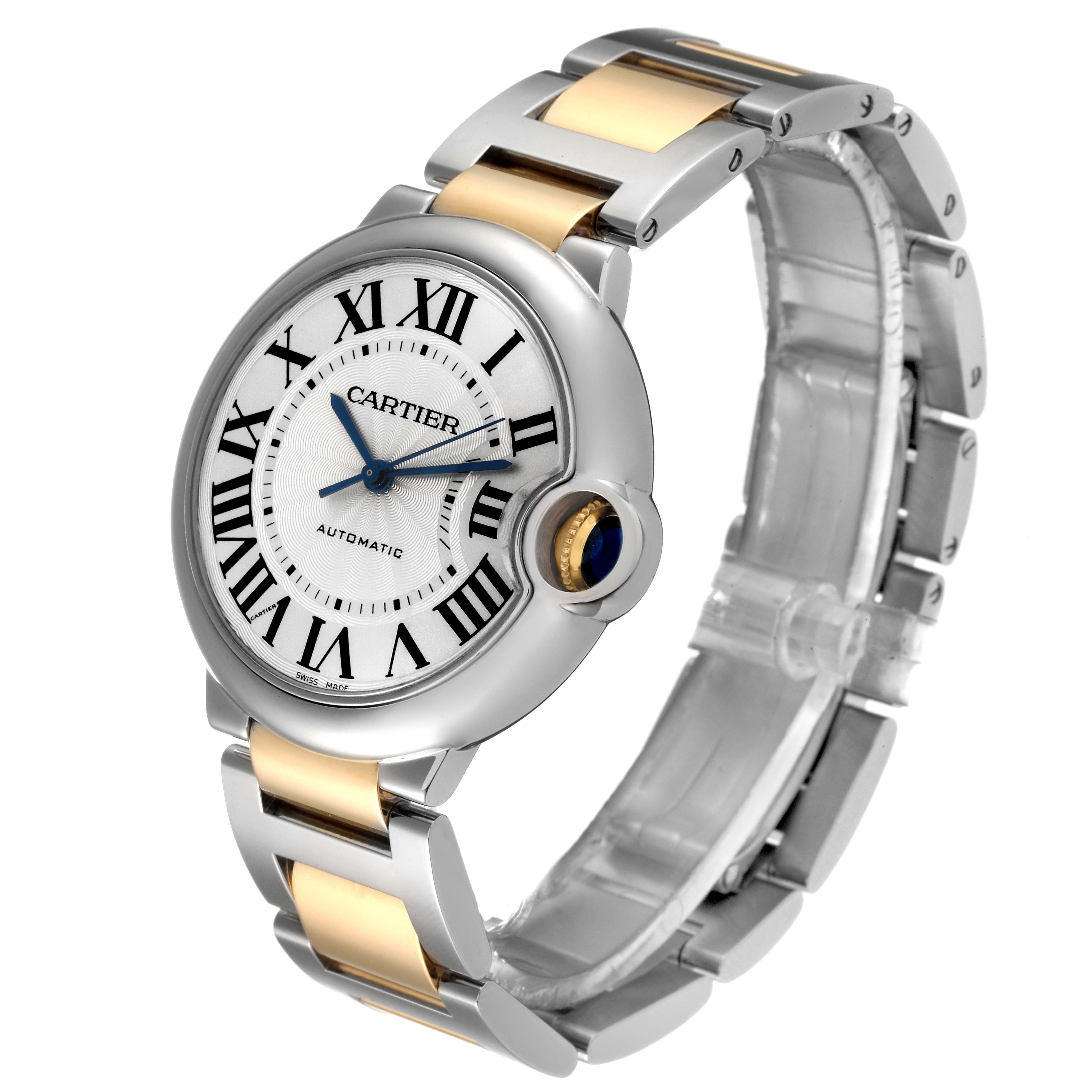 The image shows a three-quarter view of a Cartier Ballon Bleu W2BB0012 Women
s Steel and Gold (two tone) Silver Dial W2BB0012 Women
s Steel and Gold (two tone) Silver Dial watch, highlighting its face, bezel, and two-tone bracelet.