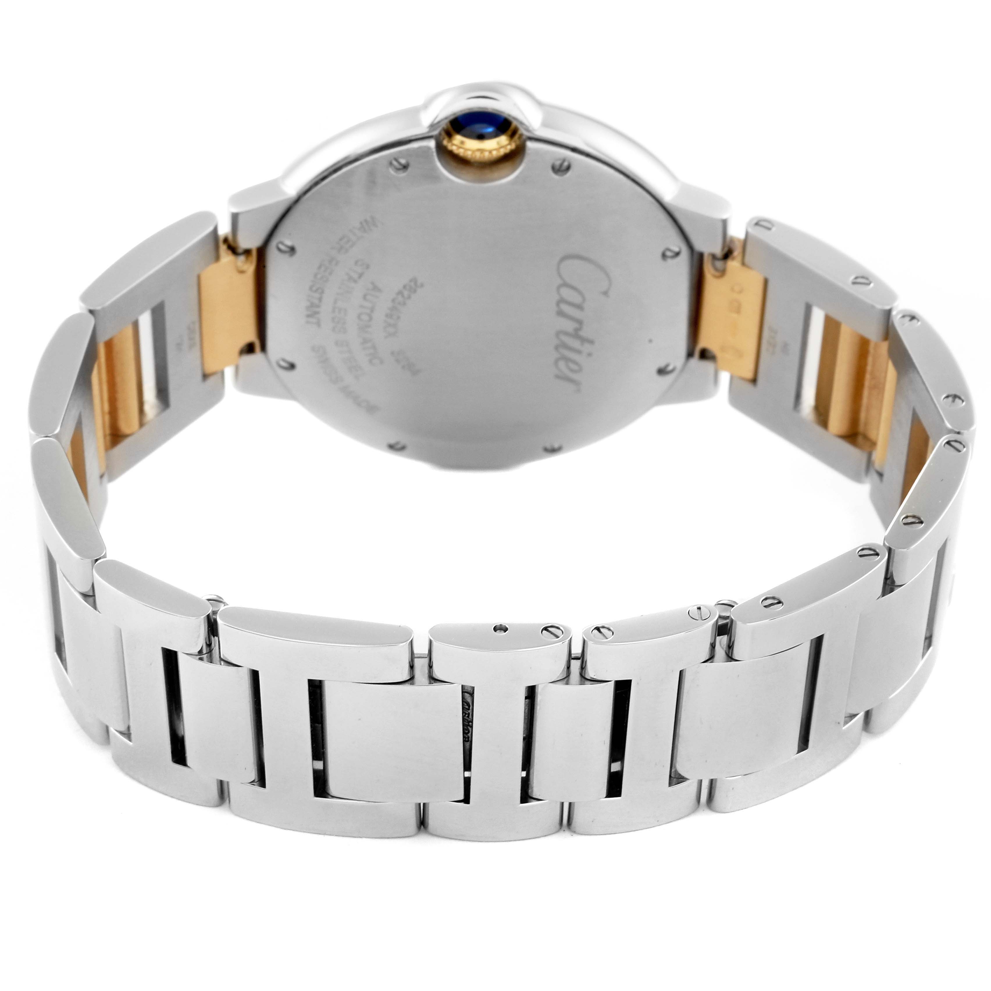 The image shows the back of a Ballon Bleu watch by Cartier, highlighting the case back and metal bracelet.